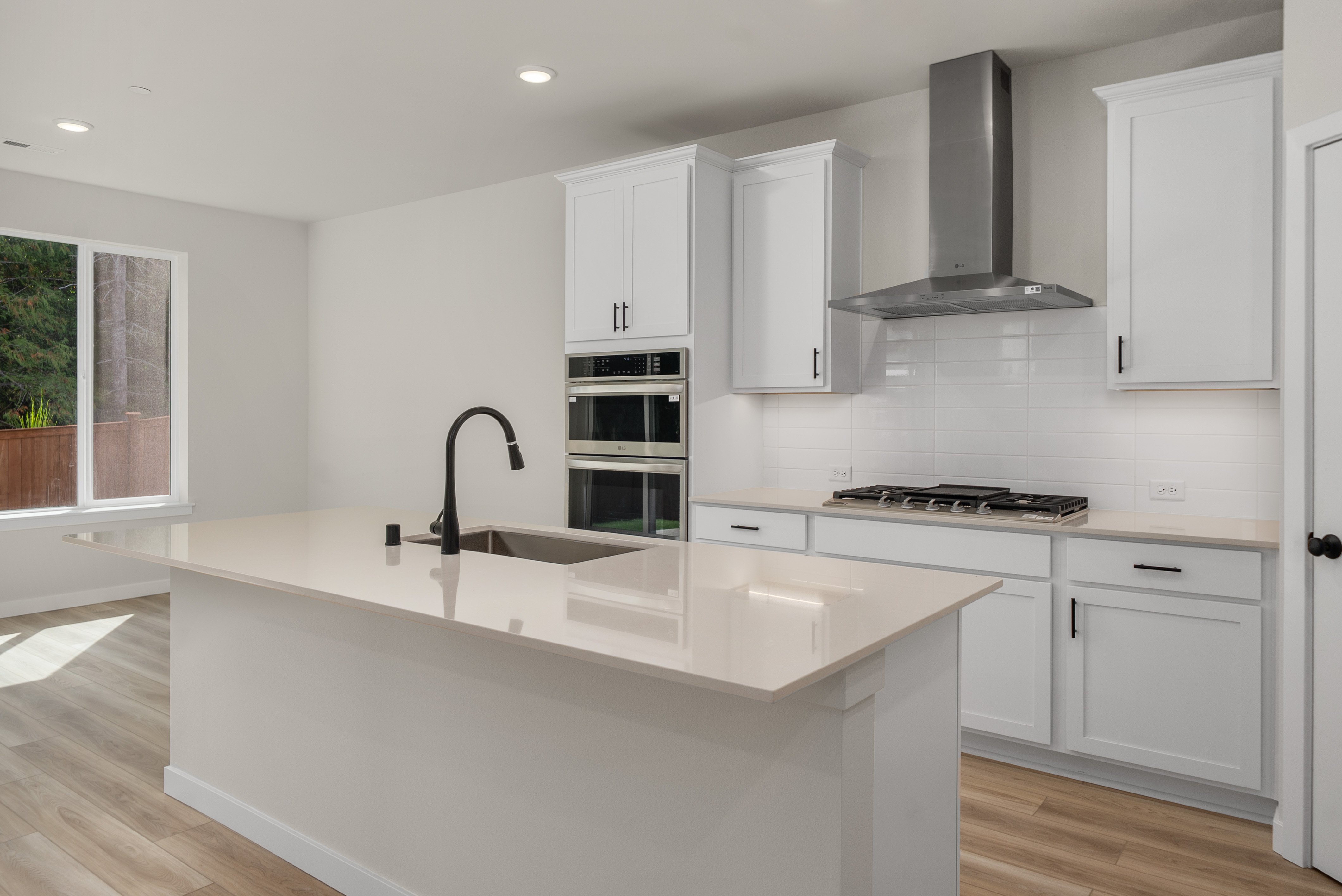 A kitchen with white cabinets.