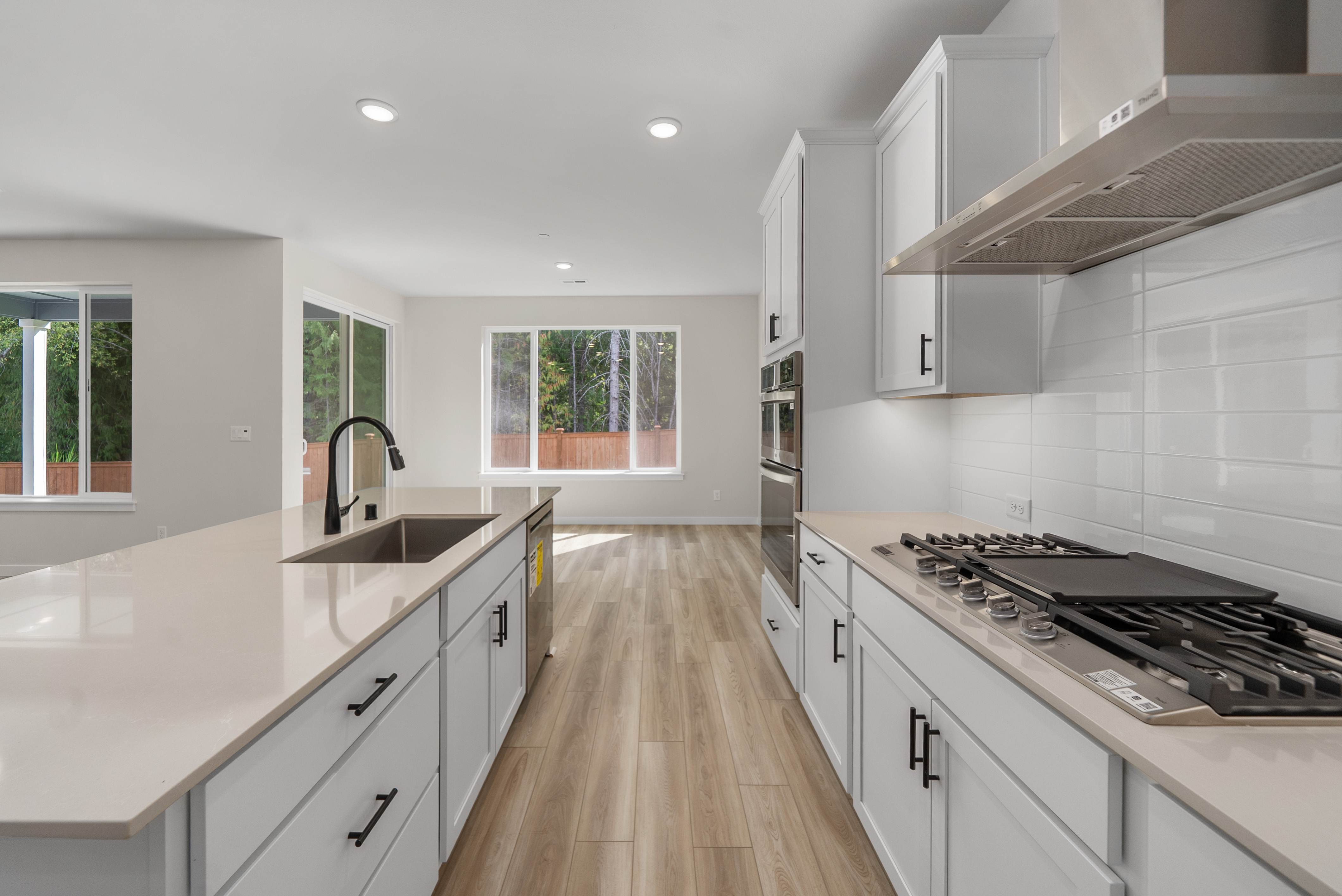 A kitchen with white cabinets.