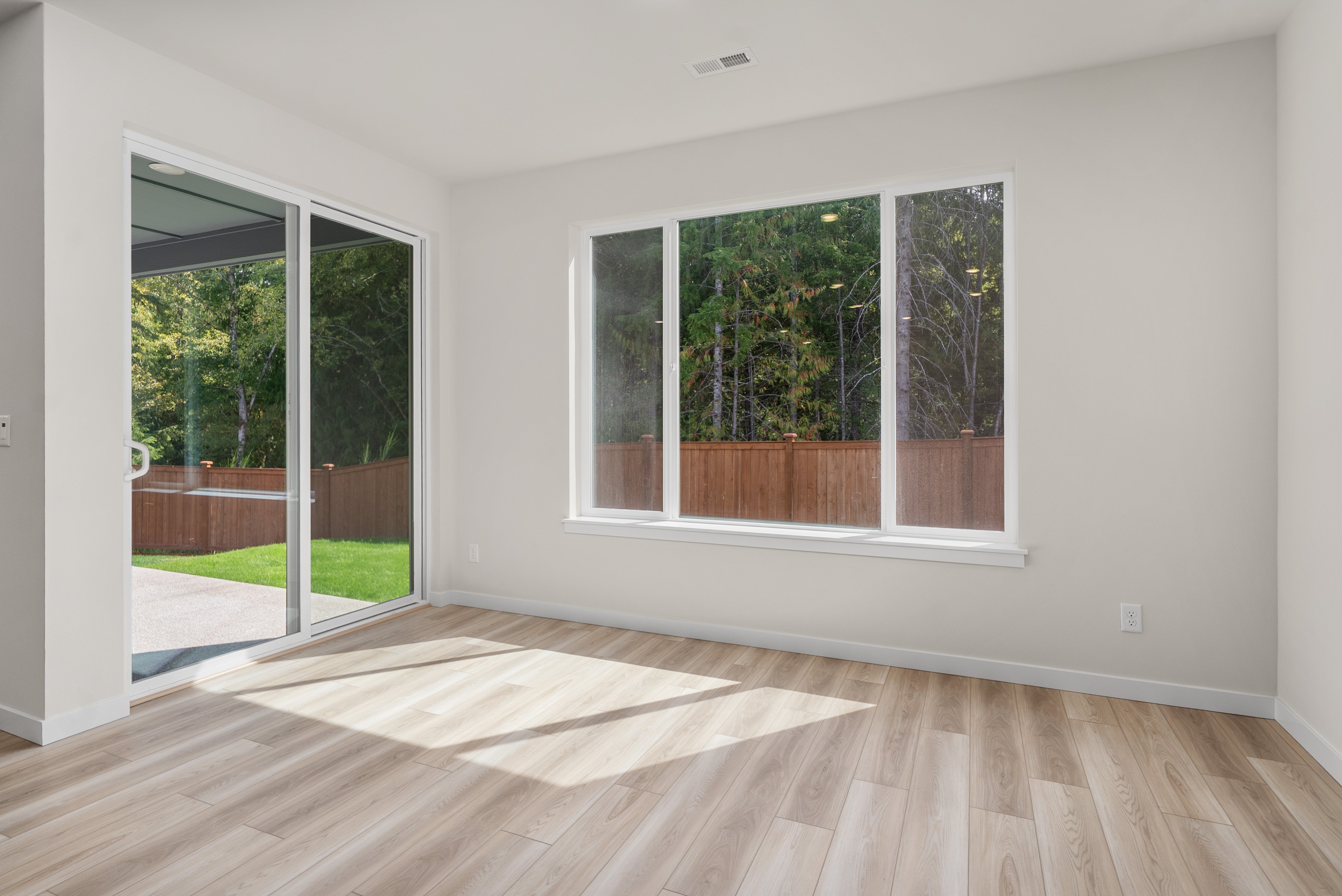 A room with a wood floor and windows.