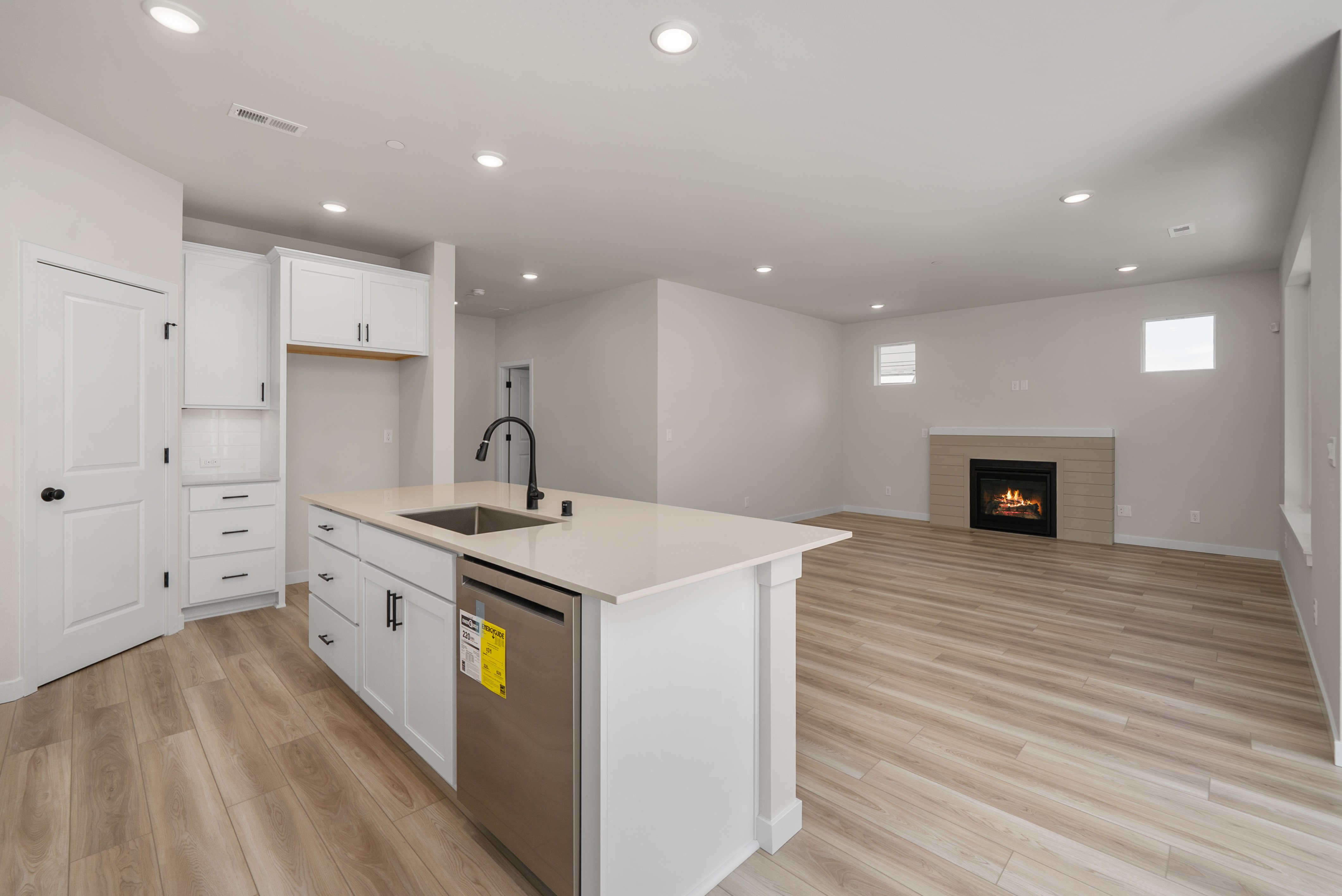 A kitchen with white cabinets.