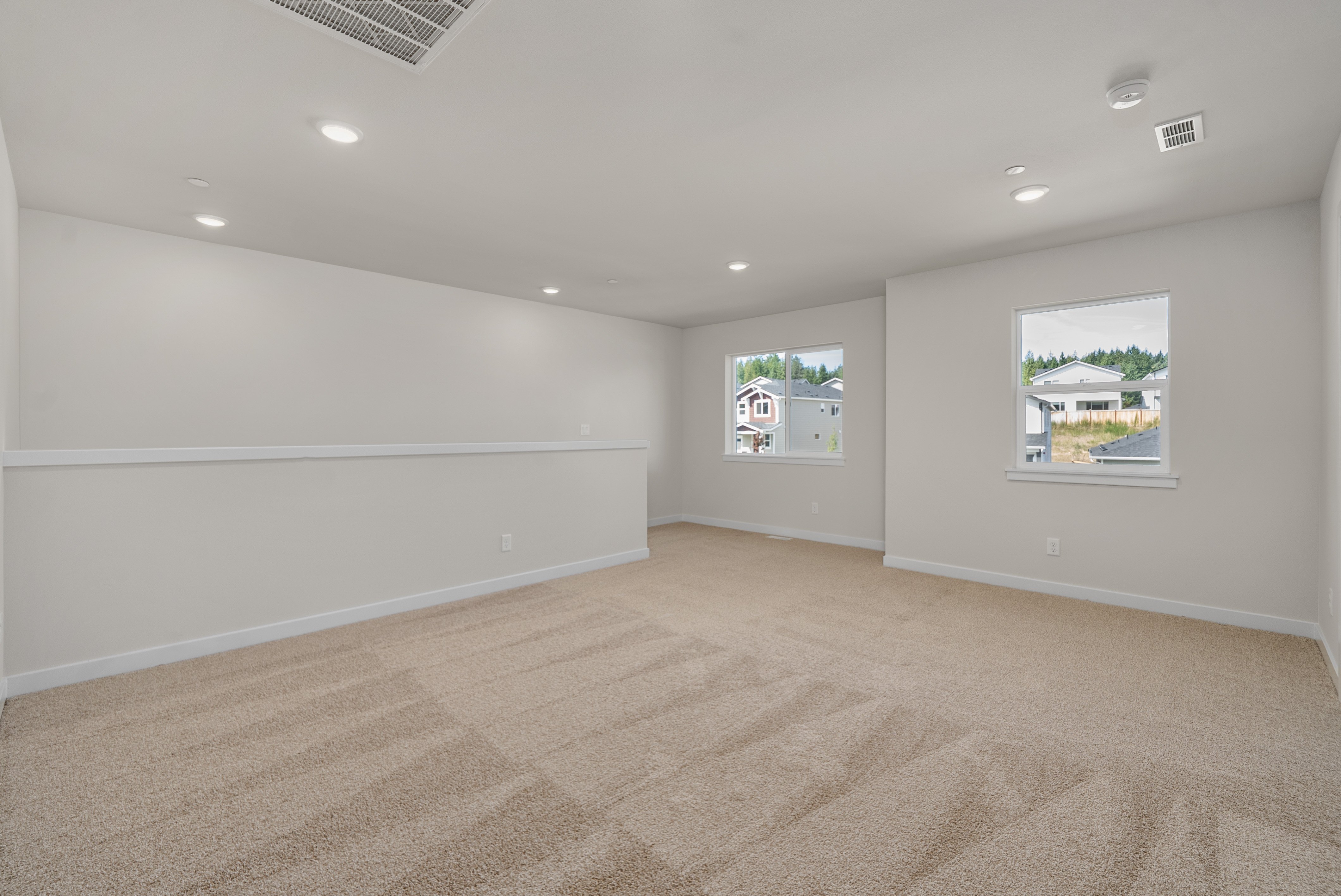 A room with a carpet and a window.
