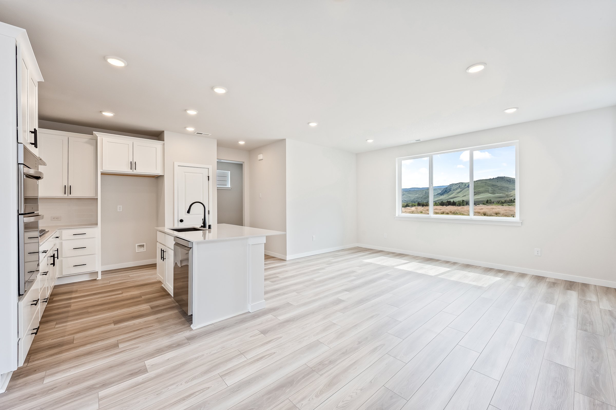 A kitchen with white cabinets.