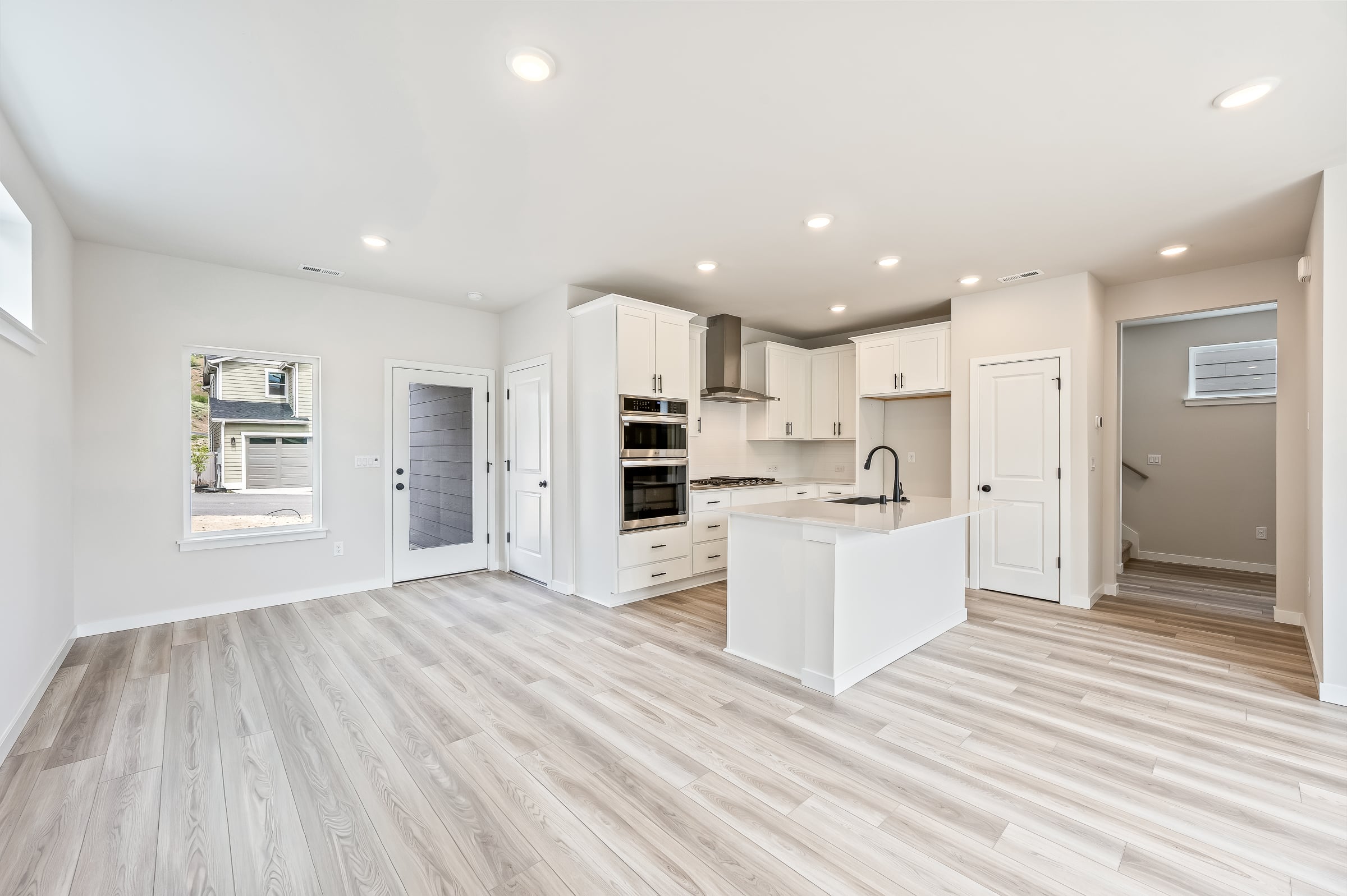 A kitchen with white cabinets.