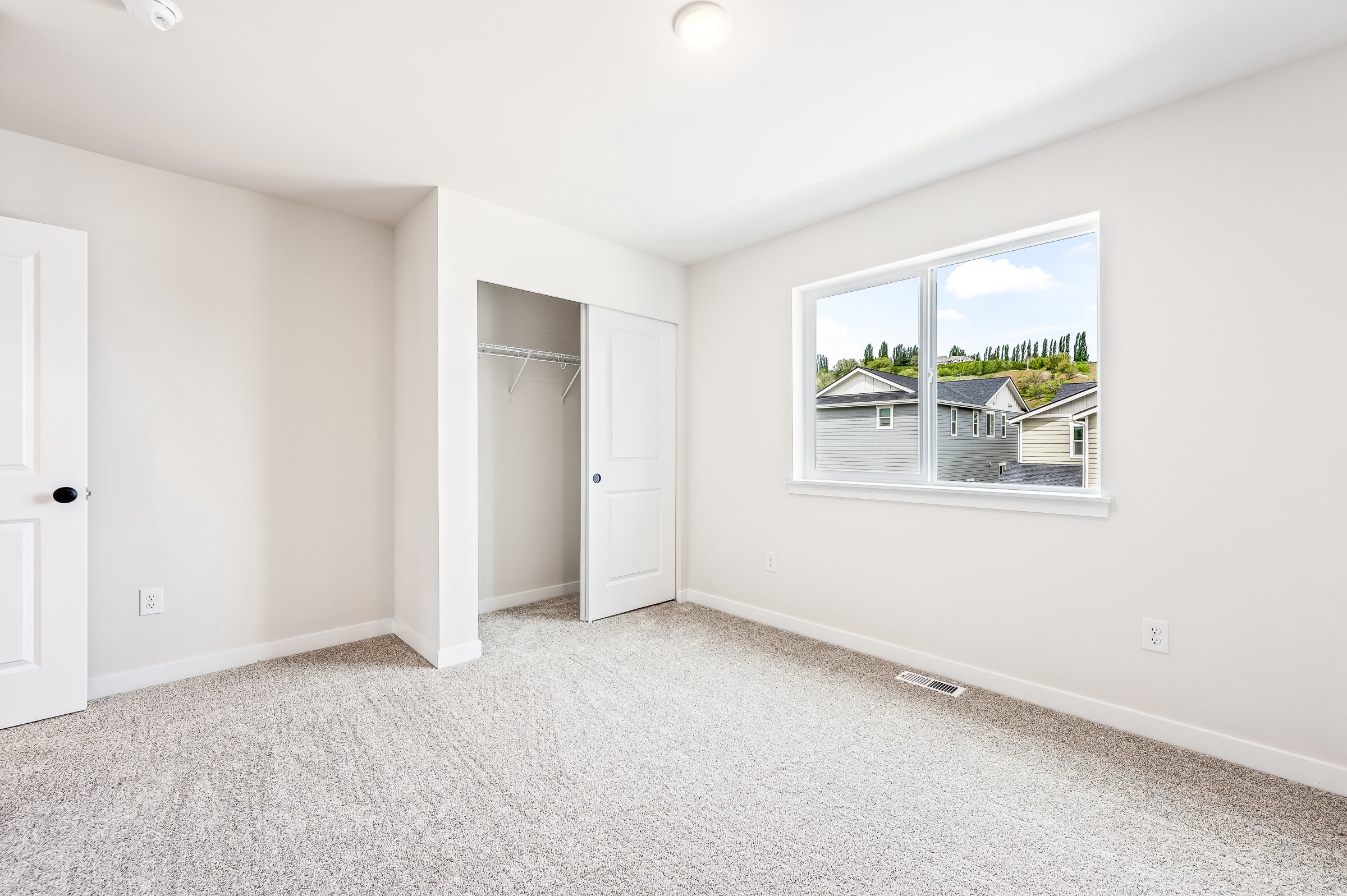 A room with a window and a door.