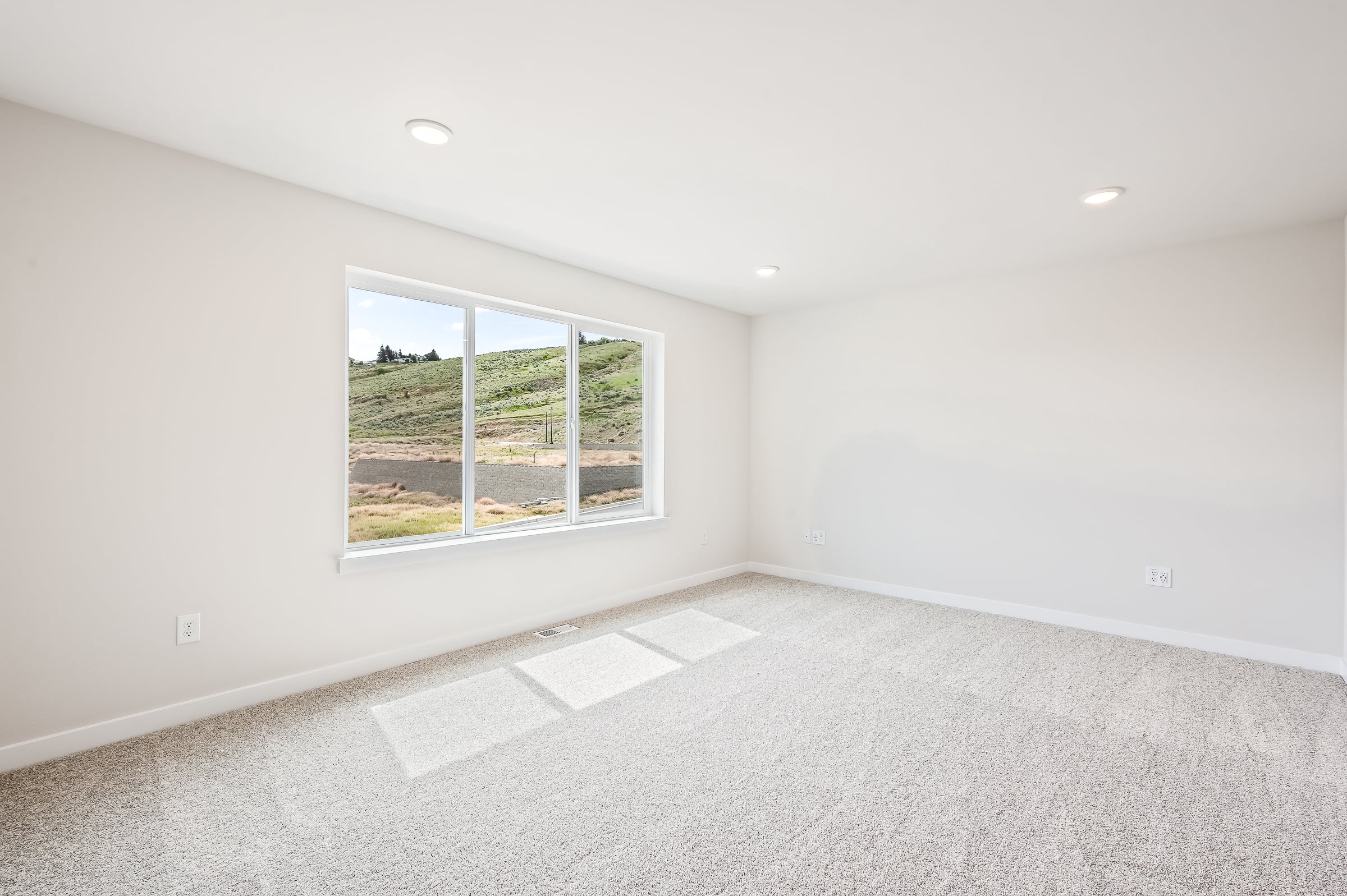 A room with a window and a tile floor.
