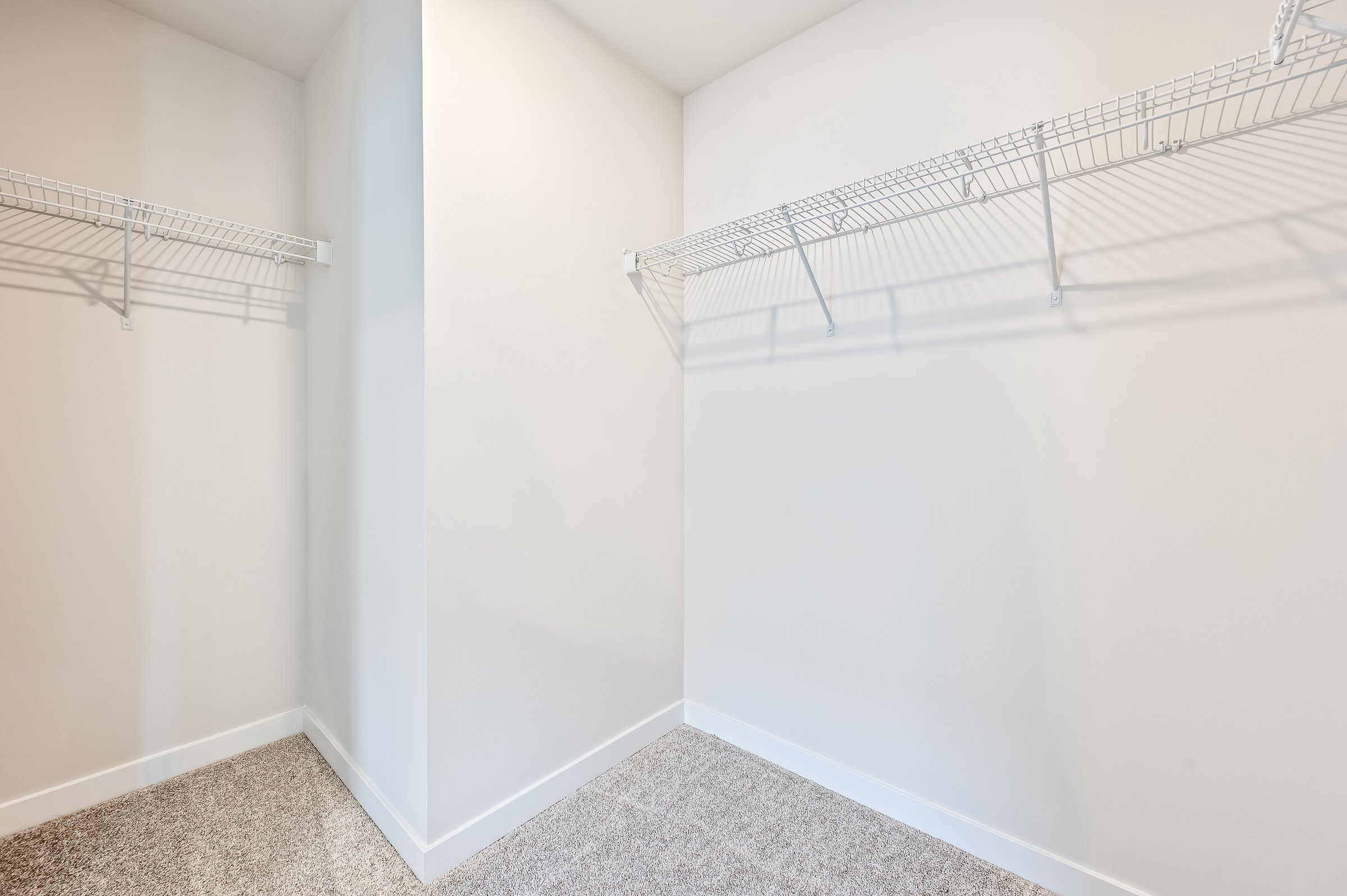 A white wall with a metal railing.
