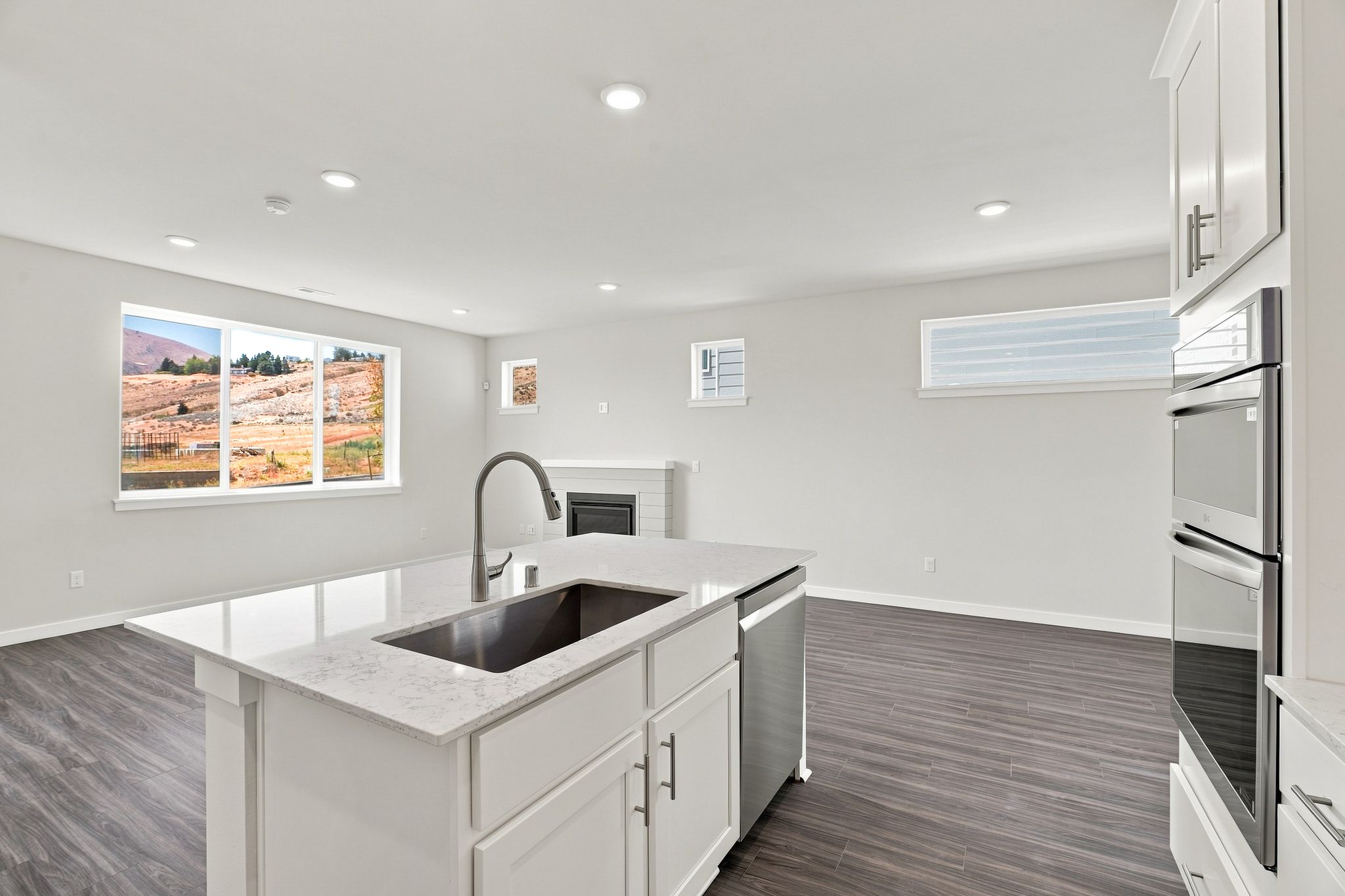 A kitchen with a sink and a large window.