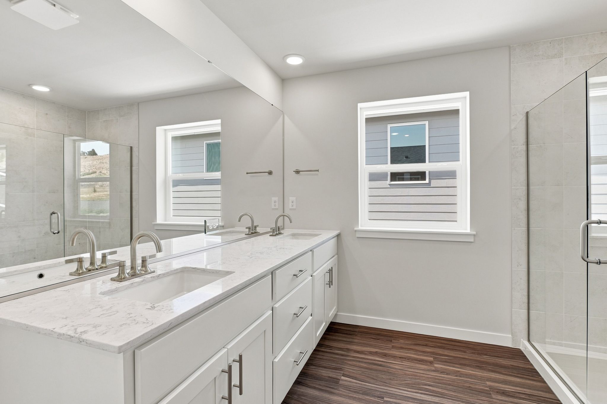 A bathroom with a sink and a shower.