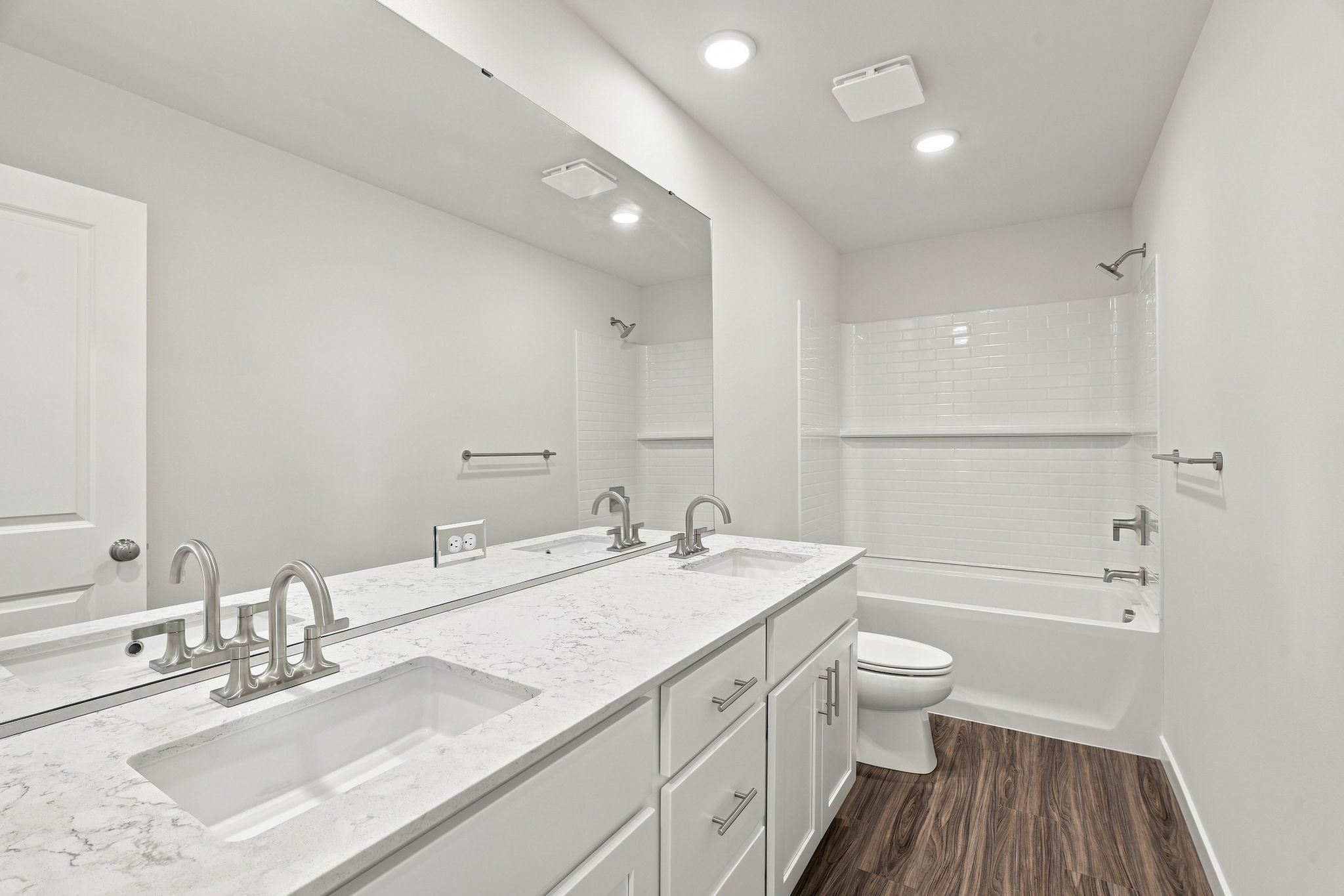 A bathroom with a tub sink and toilet.