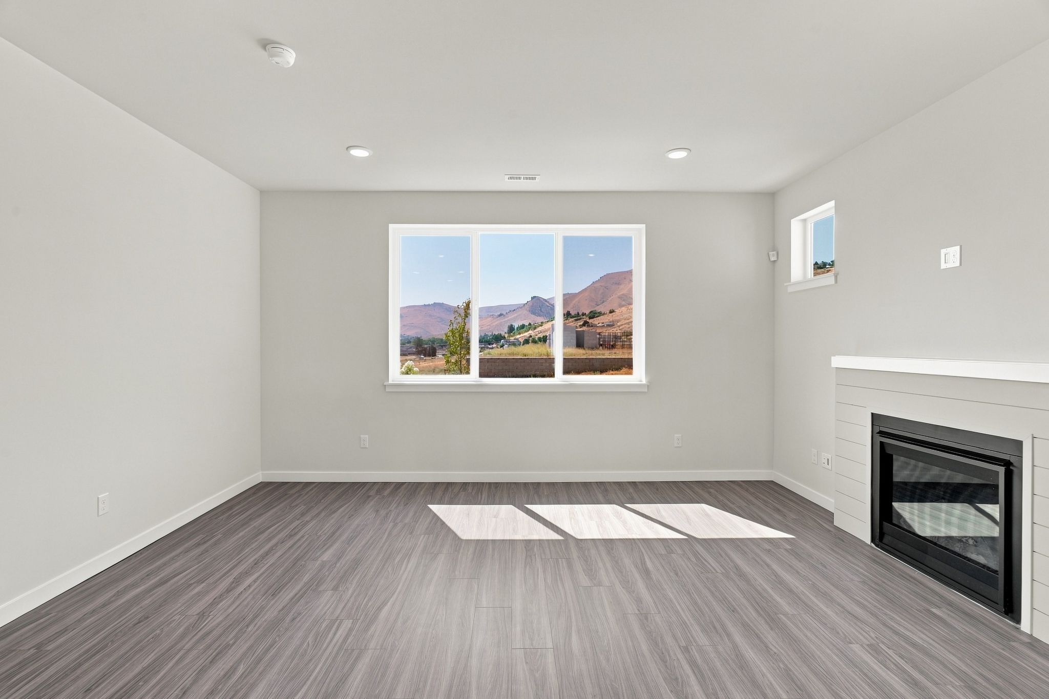 A room with a fireplace and a painting on the wall.