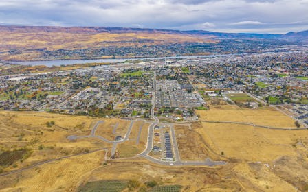 A landscape with a road and fields.
