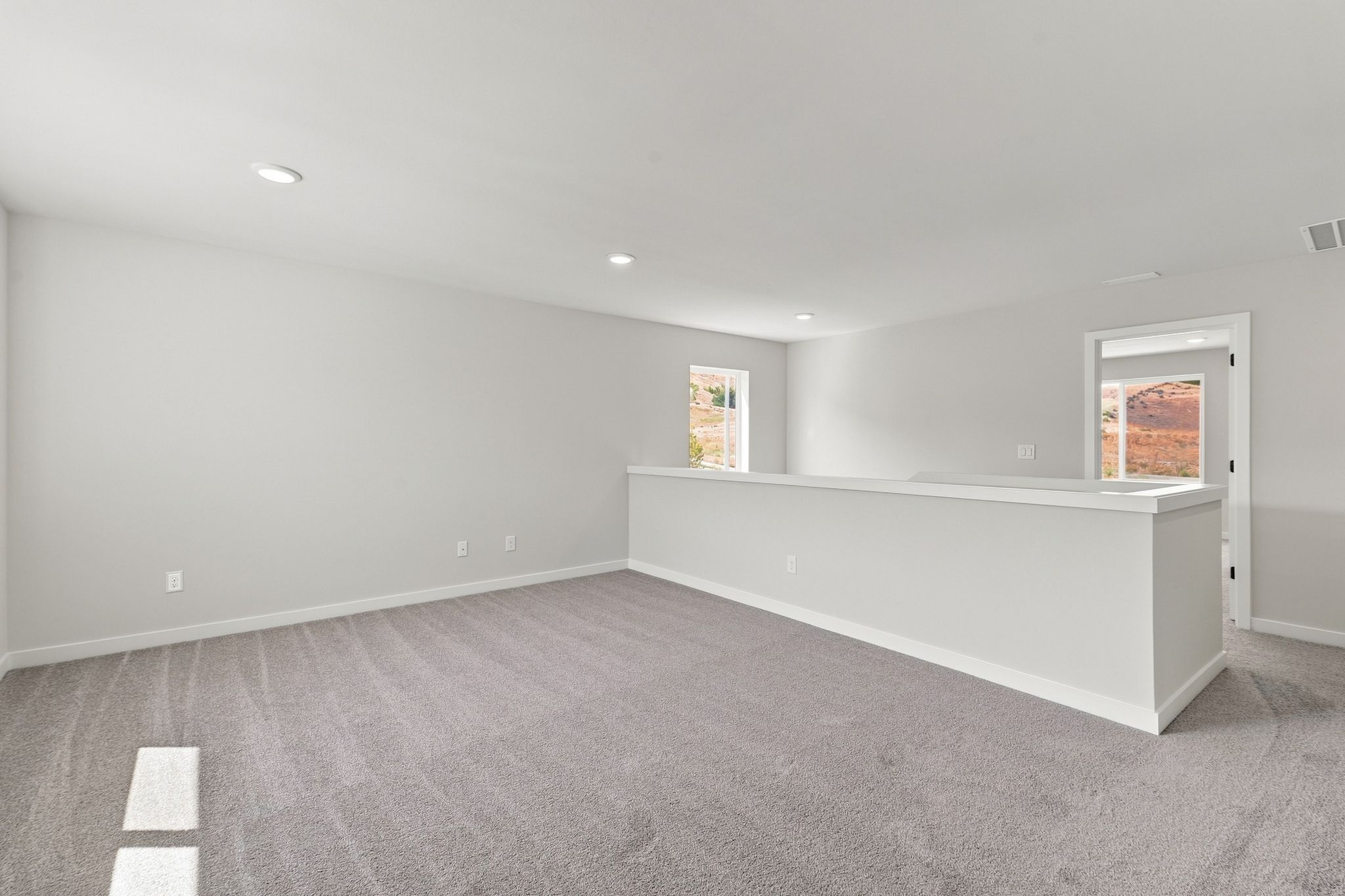 A room with a white counter and a white wall.