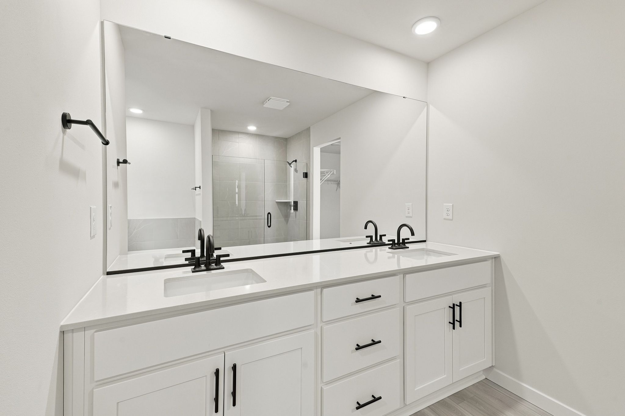 A bathroom with a large mirror.