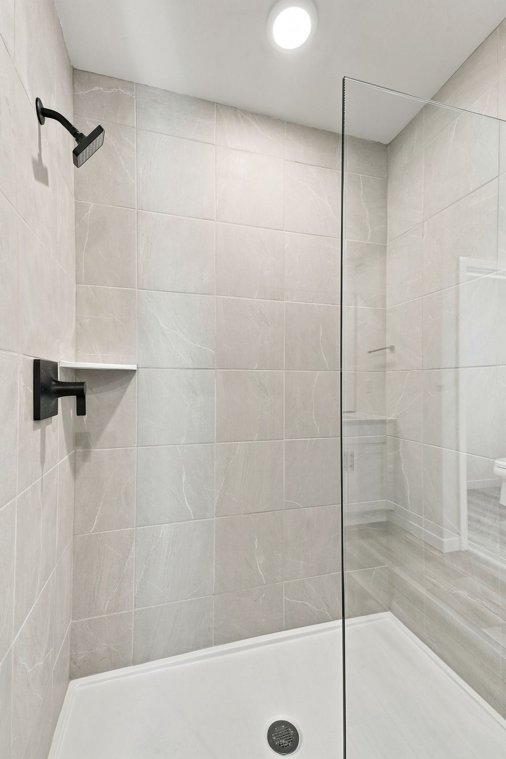 A shower with a glass door.