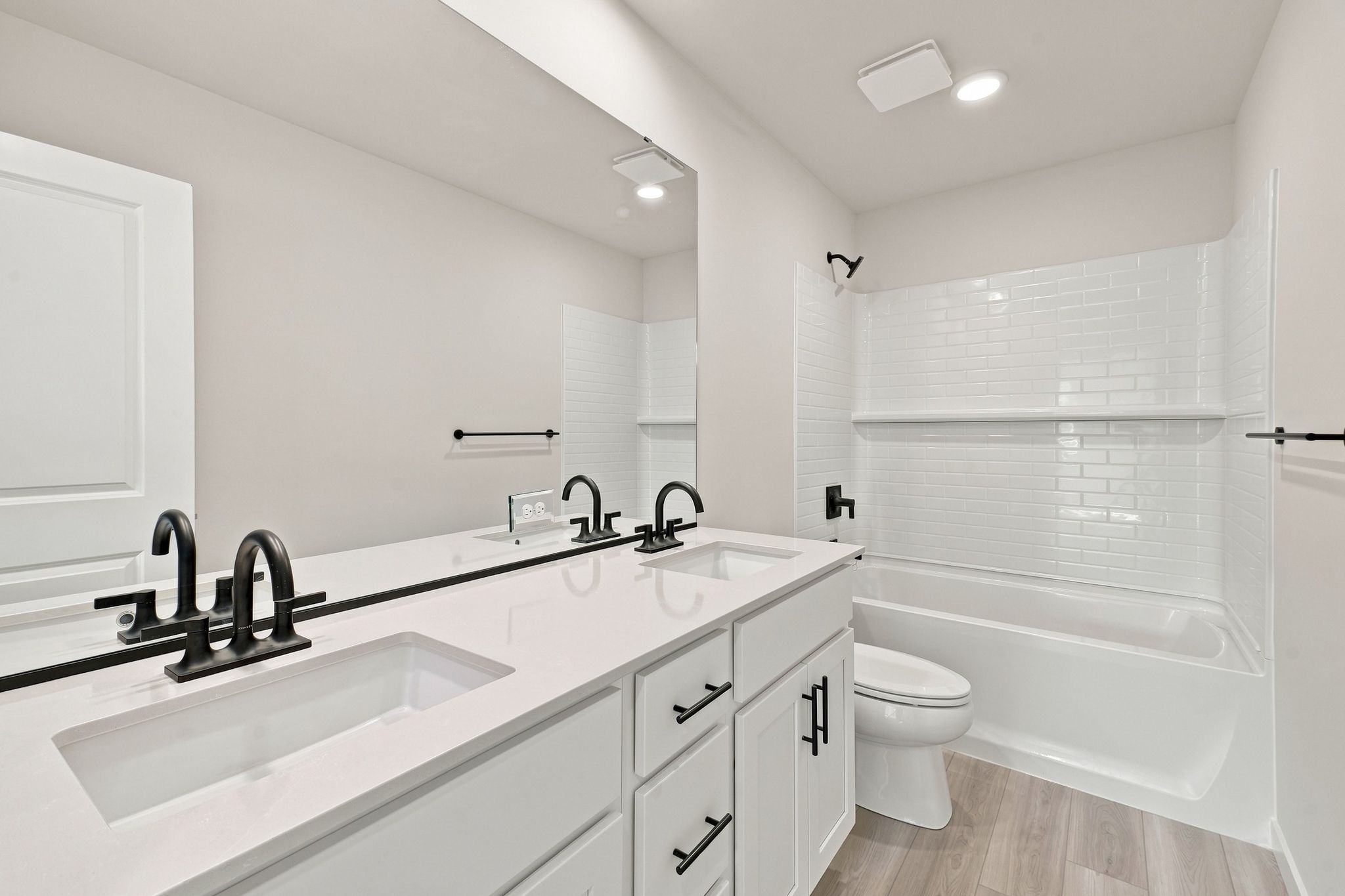 A bathroom with a tub sink and toilet.