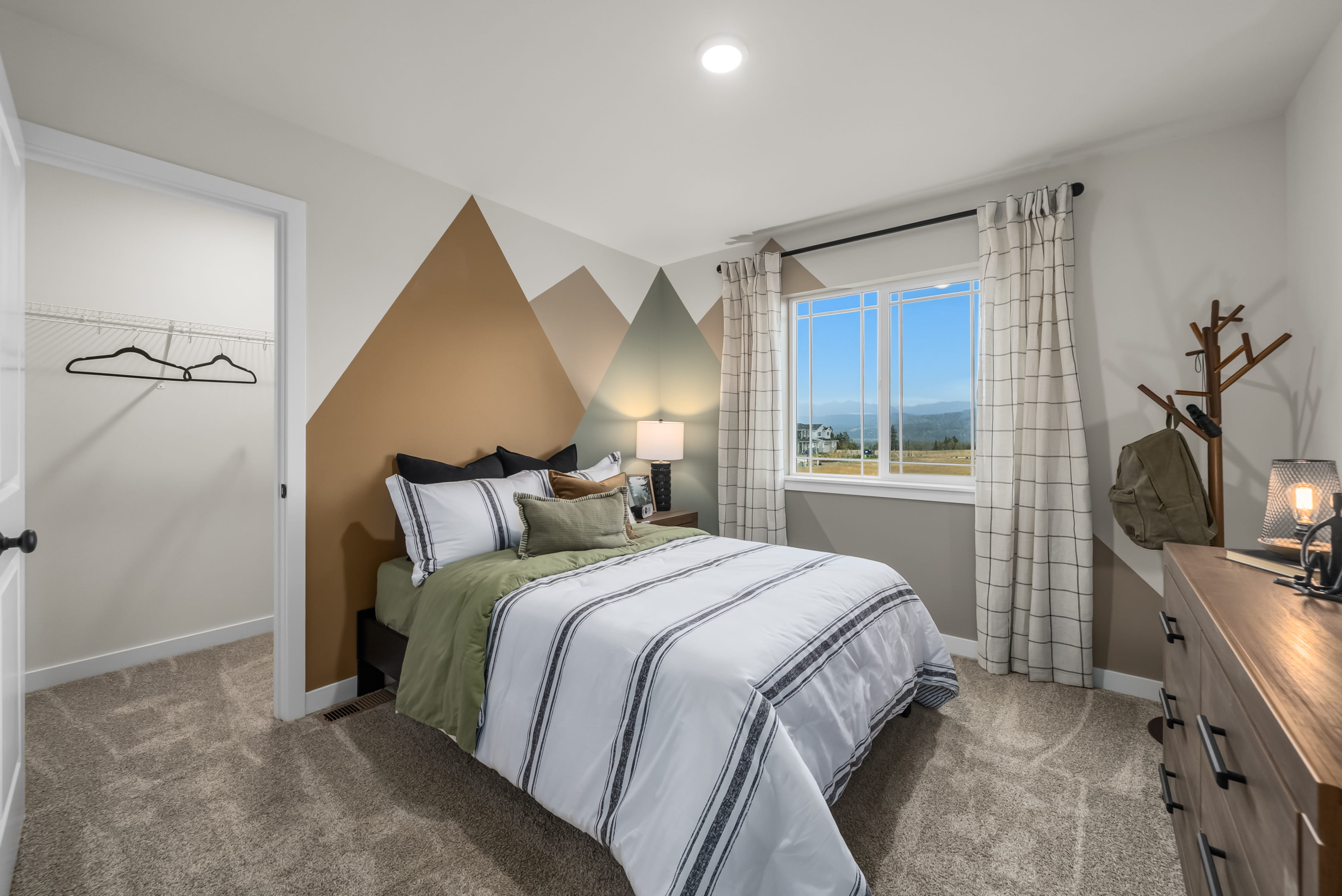 A bedroom with a bed and a window.