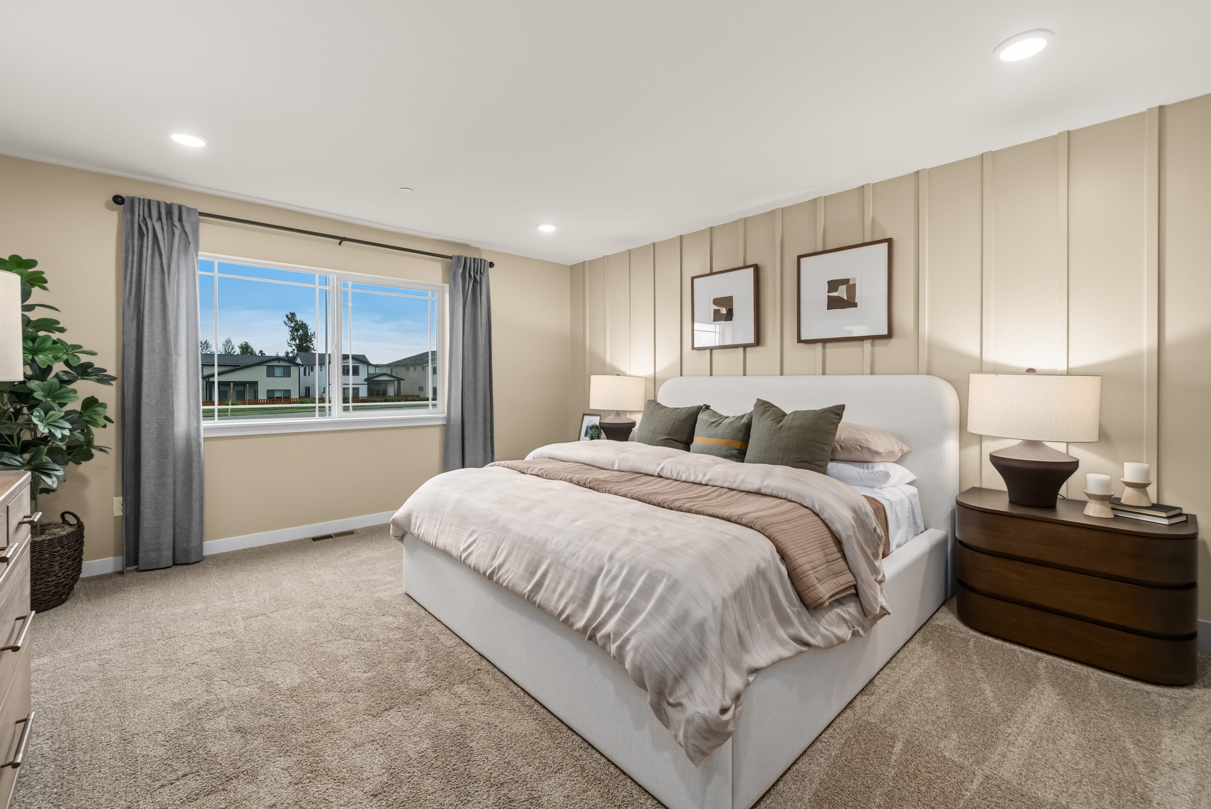 A bedroom with a large window.