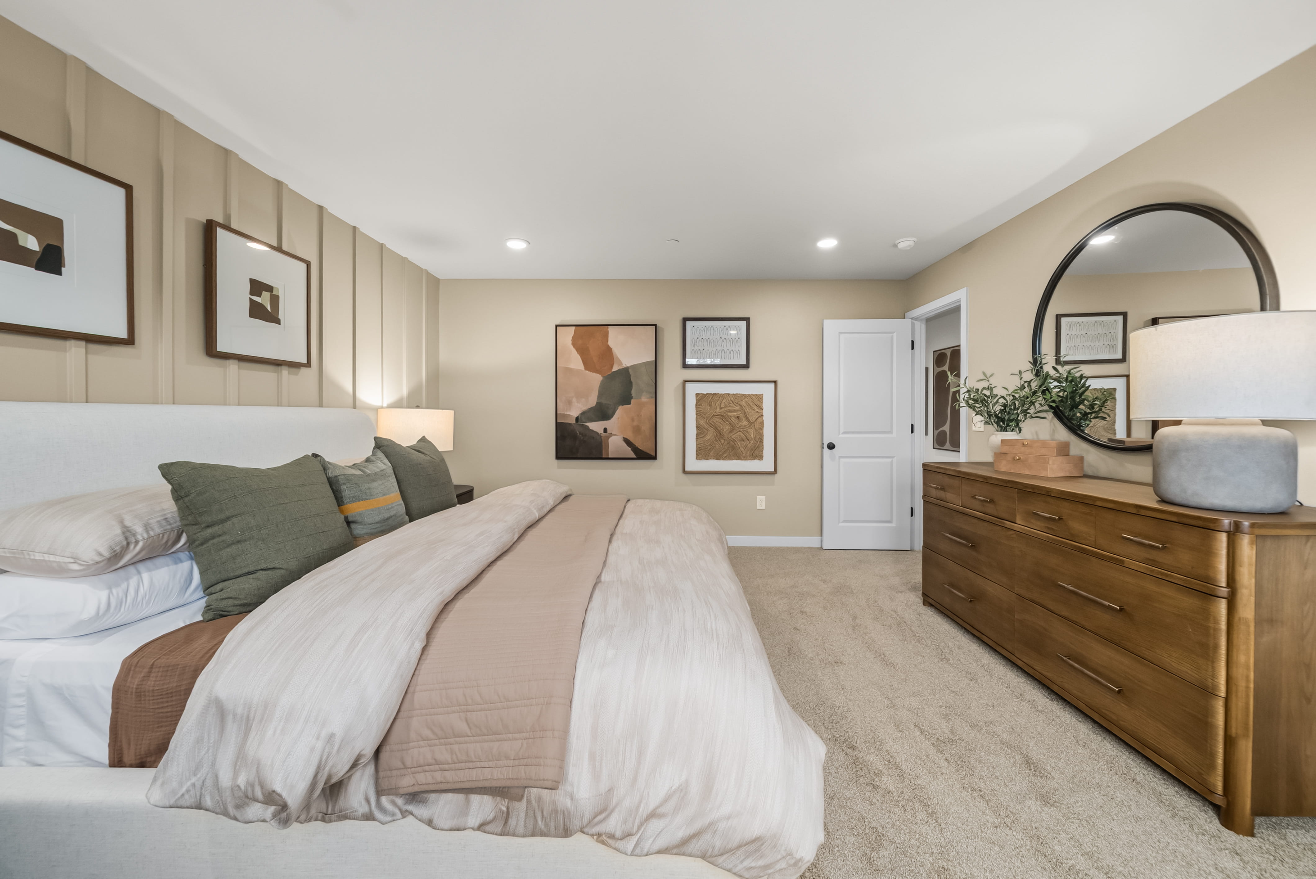 A bedroom with a bed and a dresser.