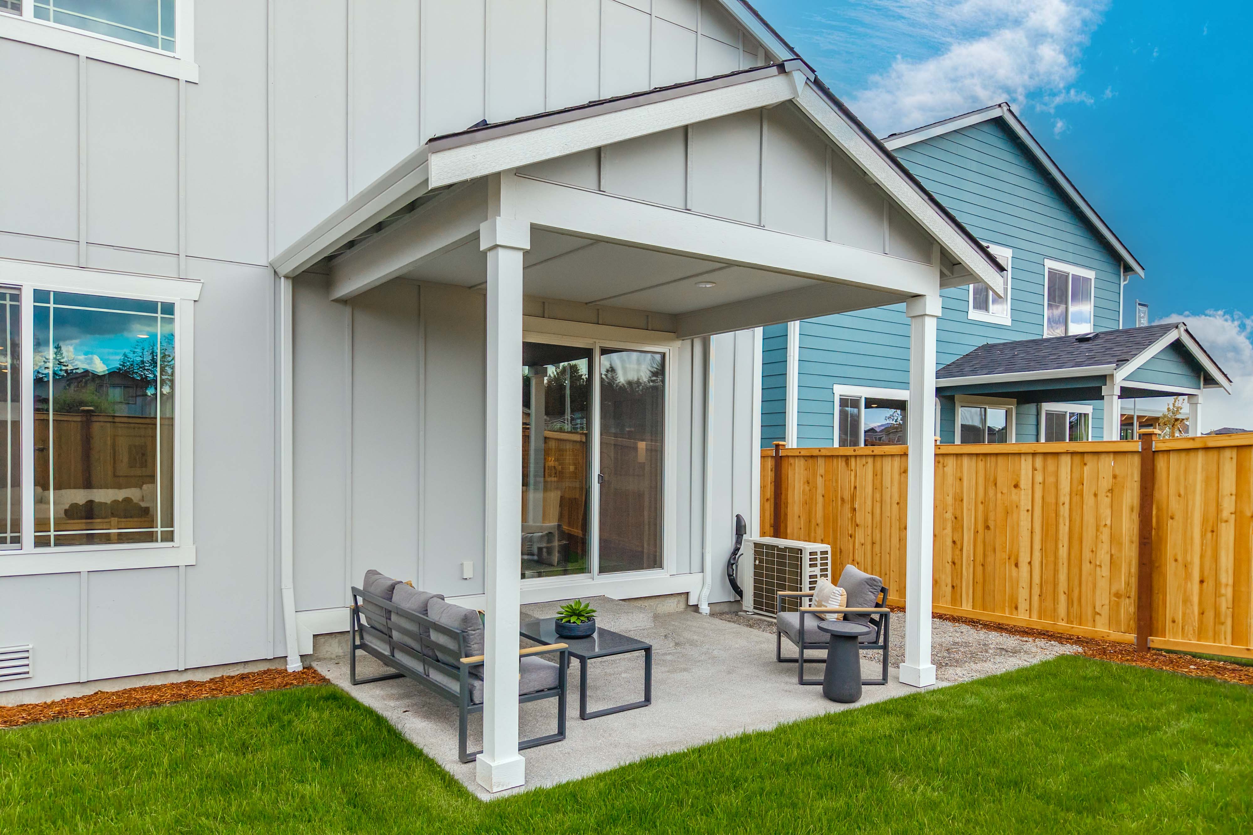 A house with a patio and a wood fence.