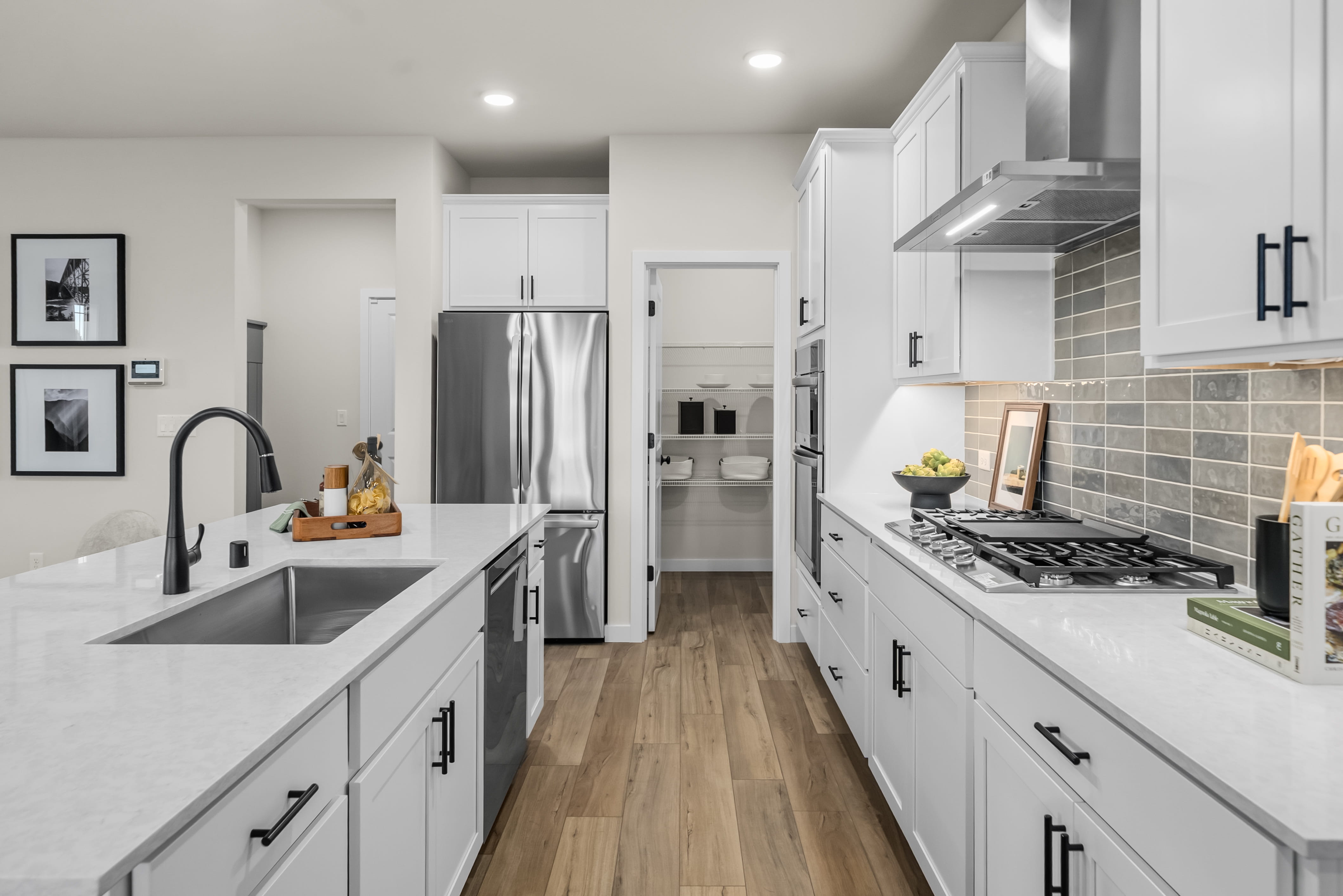 A kitchen with white cabinets.