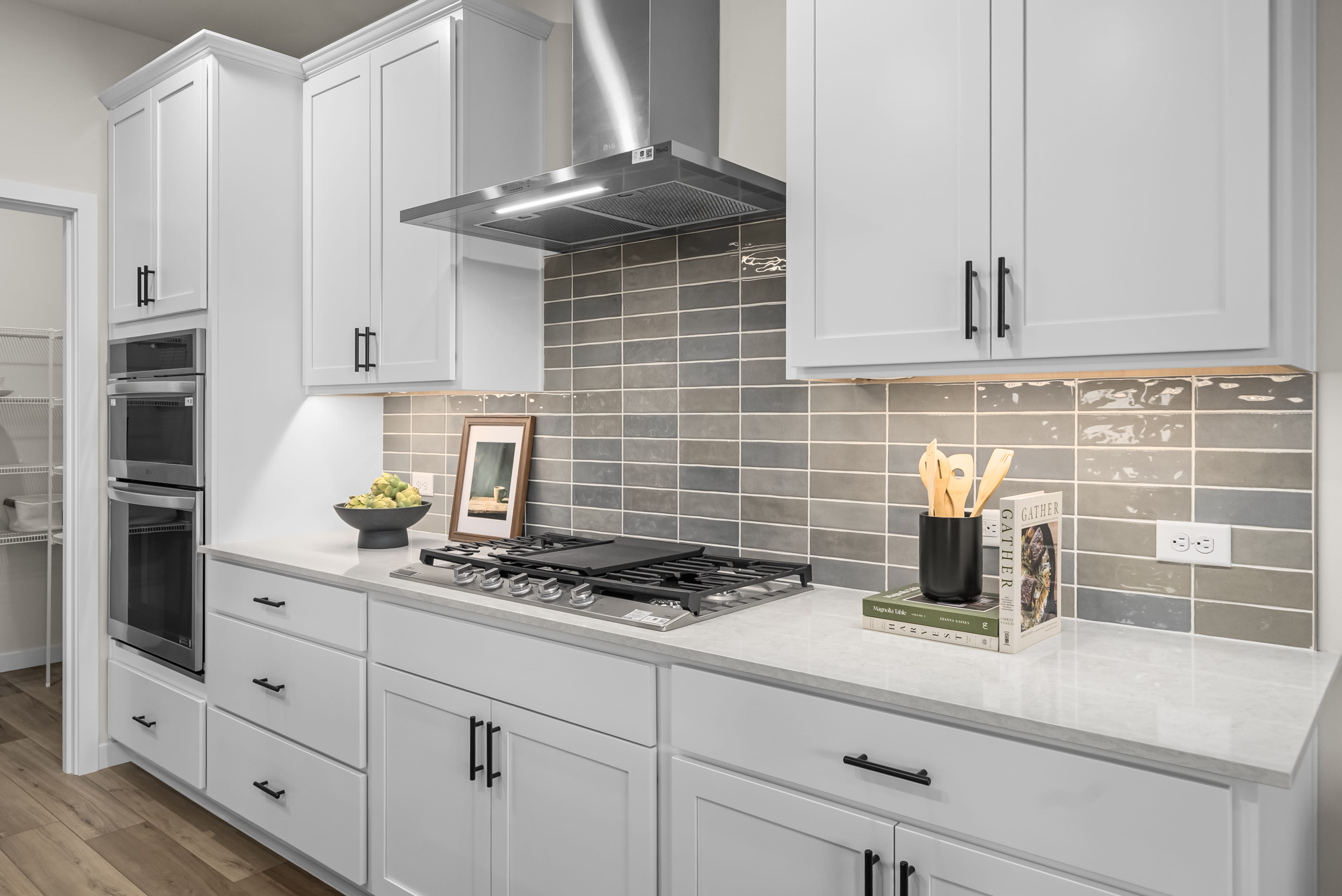 A kitchen with white cabinets.