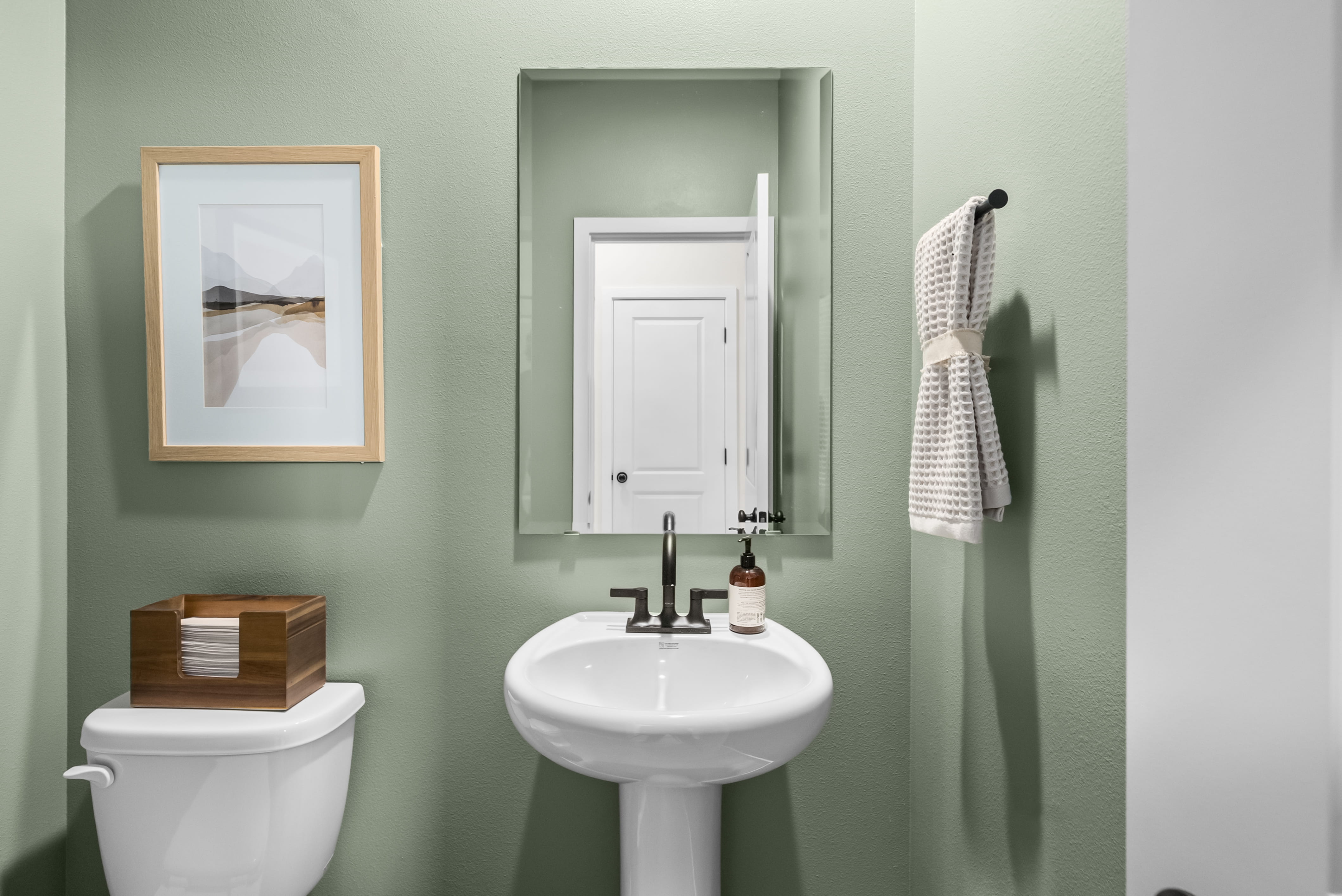 A bathroom with a sink and a mirror.