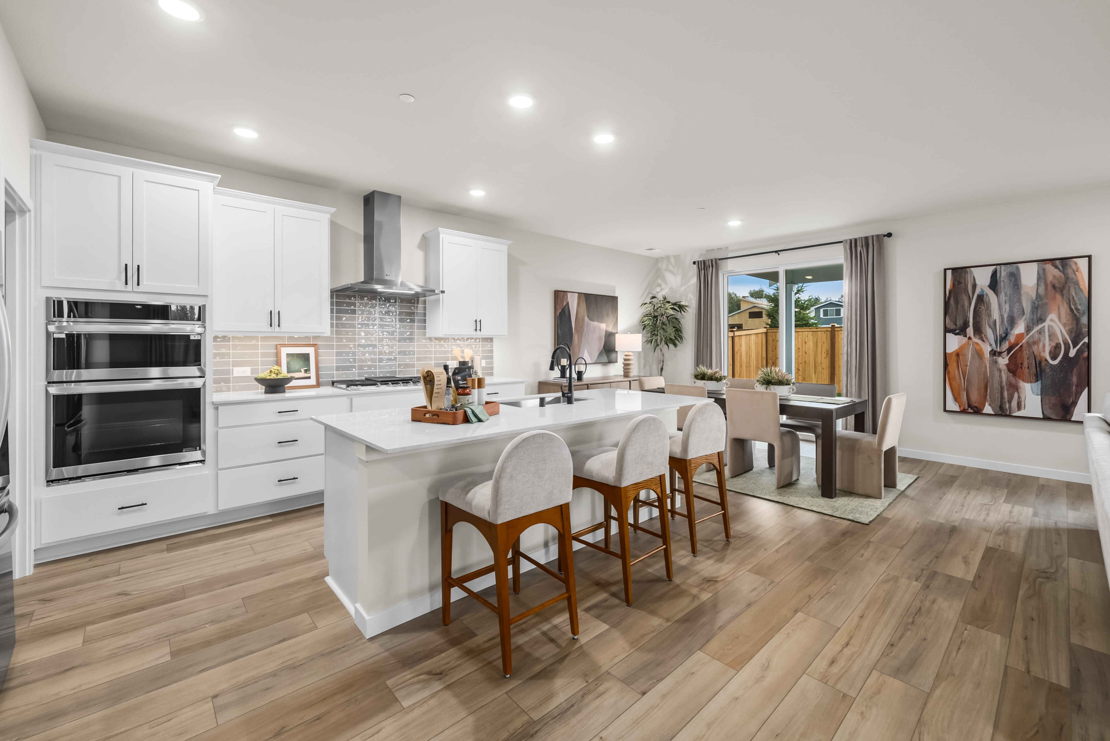 A kitchen with white cabinets.