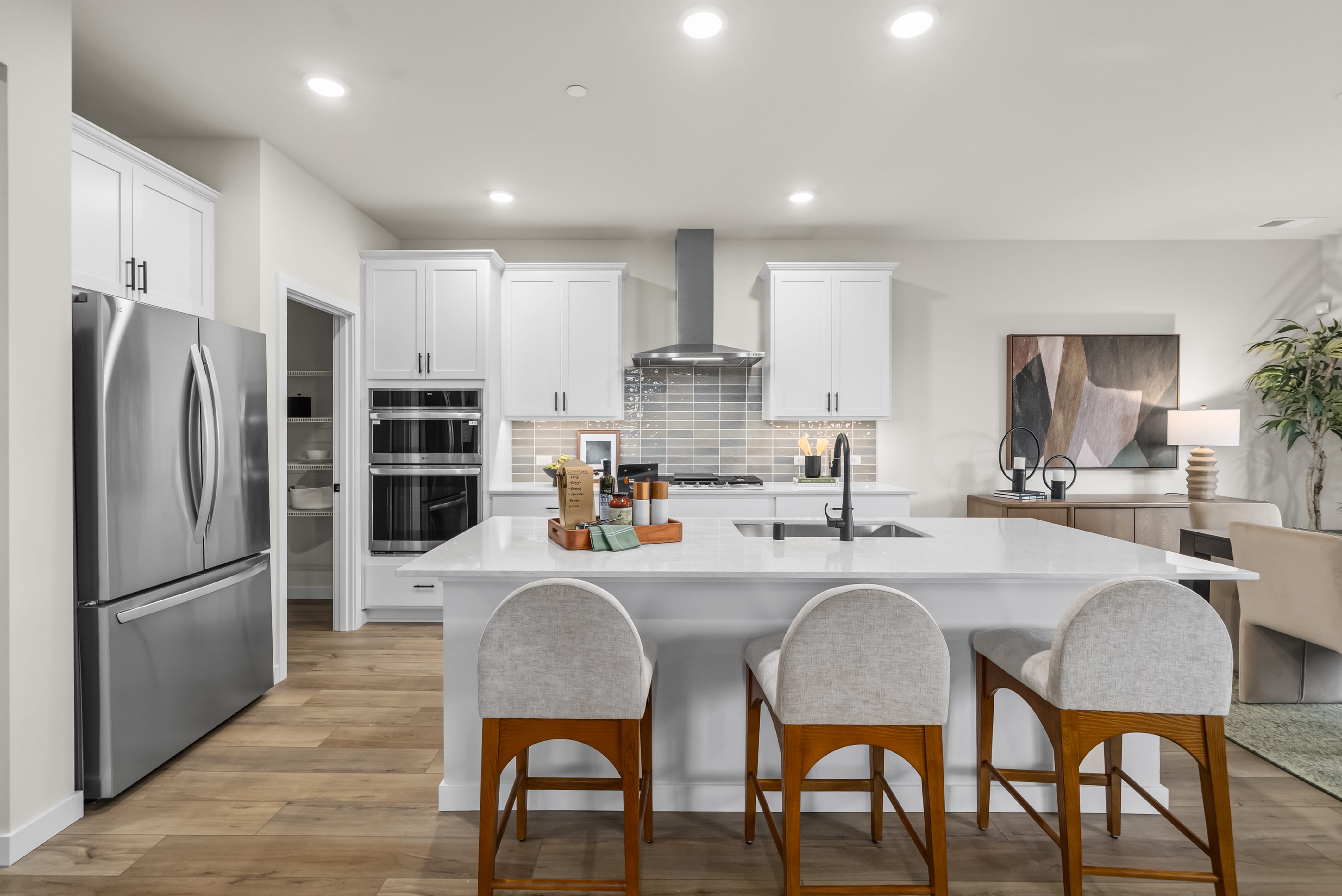 A kitchen with white cabinets.