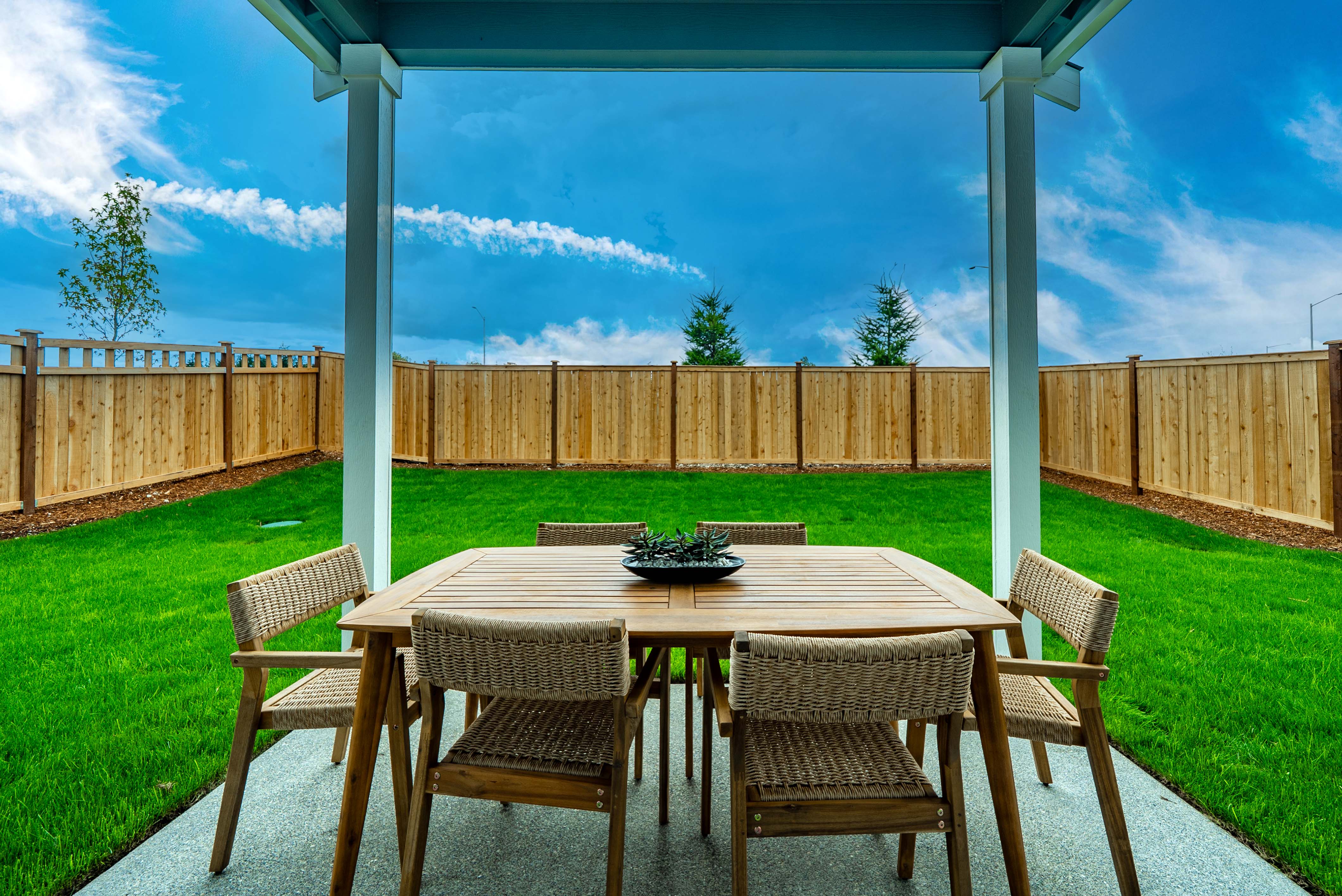 A table and chairs on a deck.