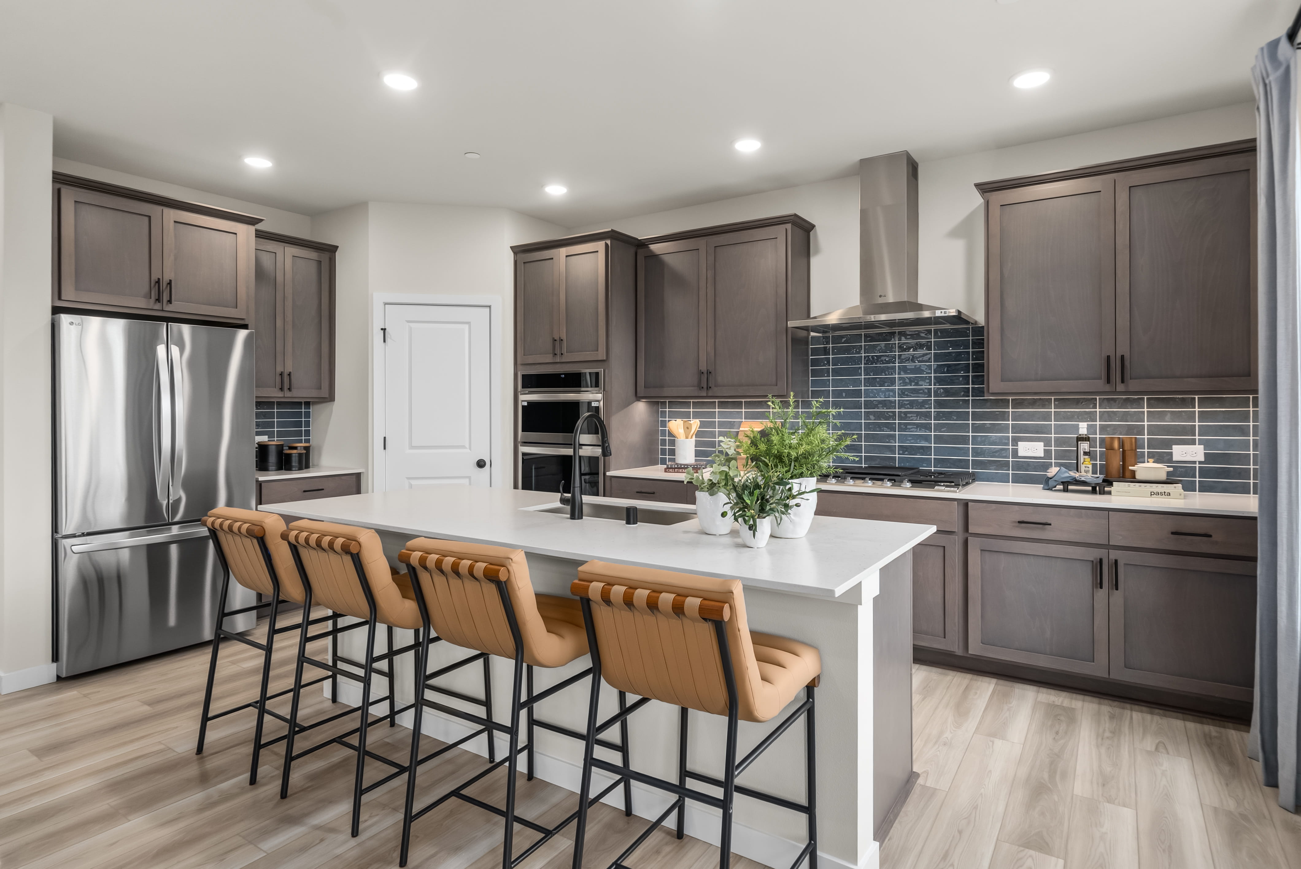 A kitchen with a table and chairs.