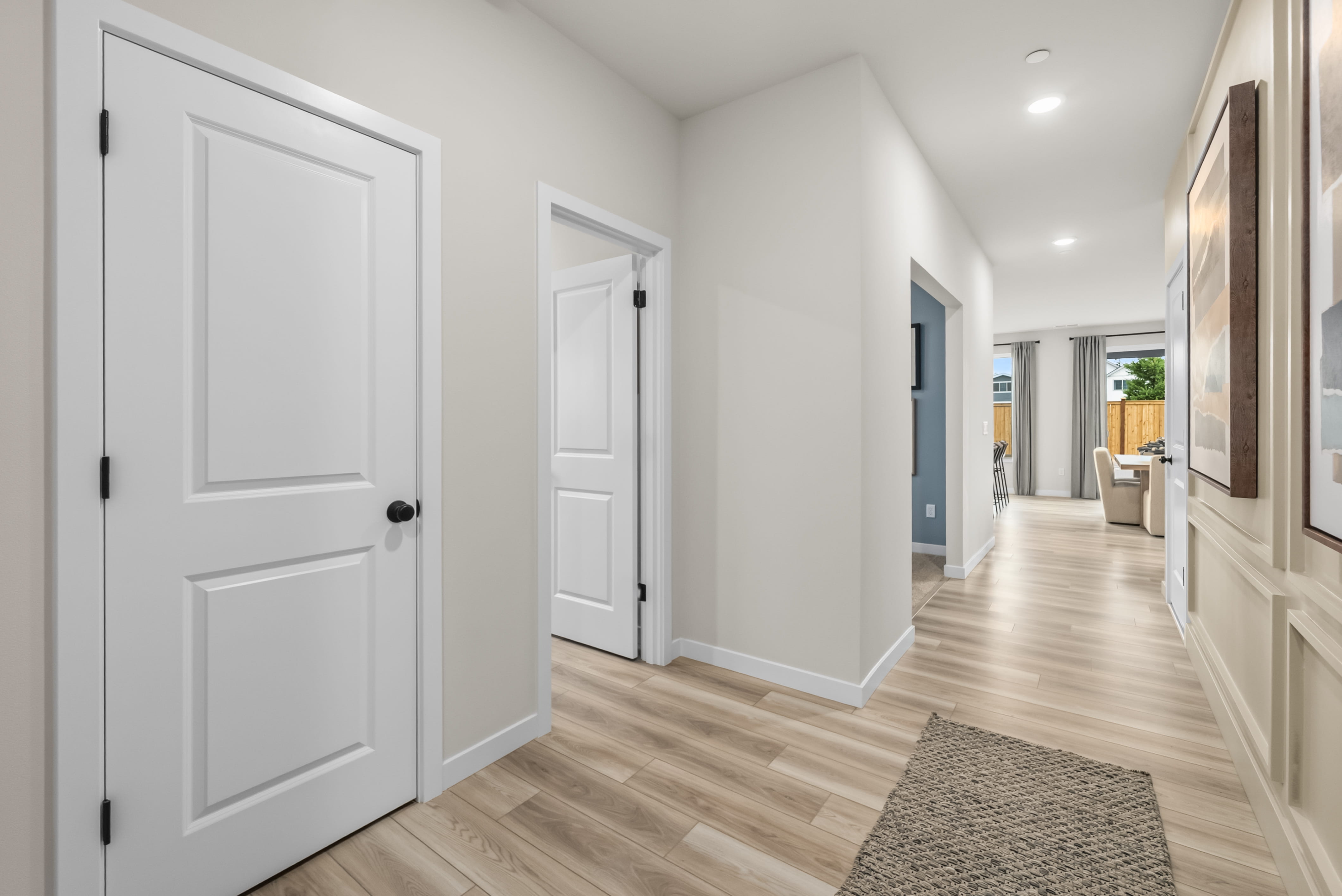 A hallway with white doors.