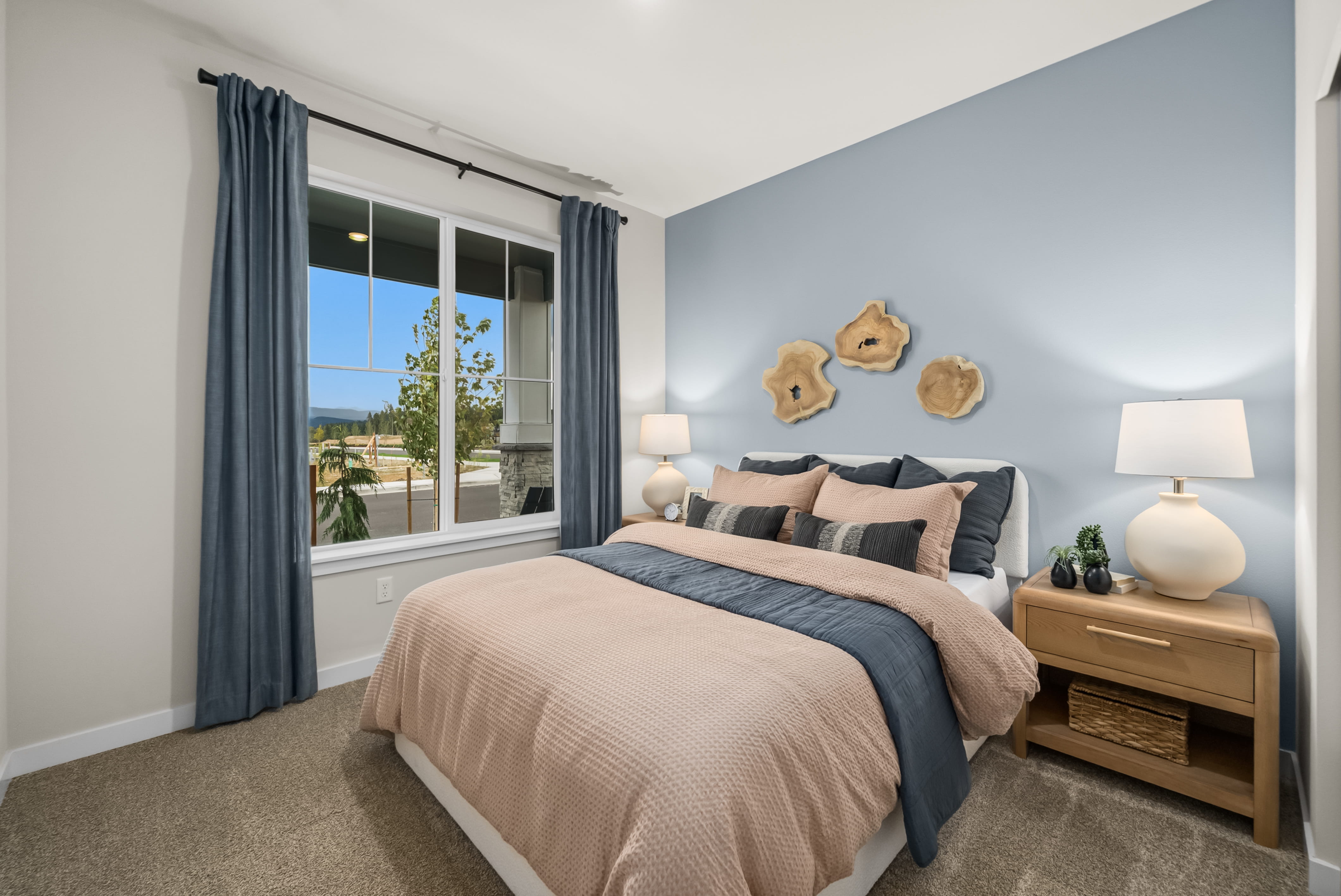 A bedroom with a bed and a window.