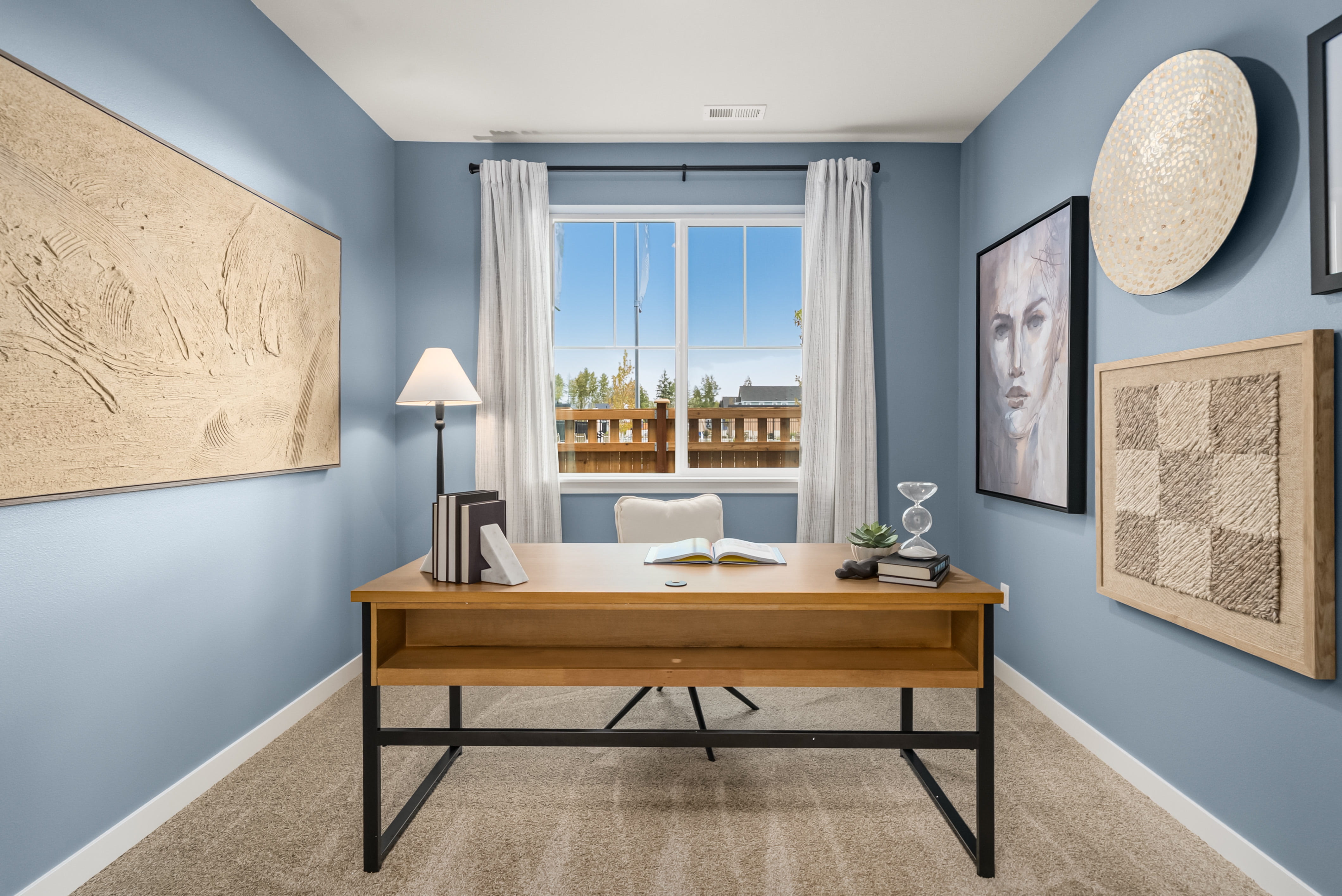 A room with a desk and a window.