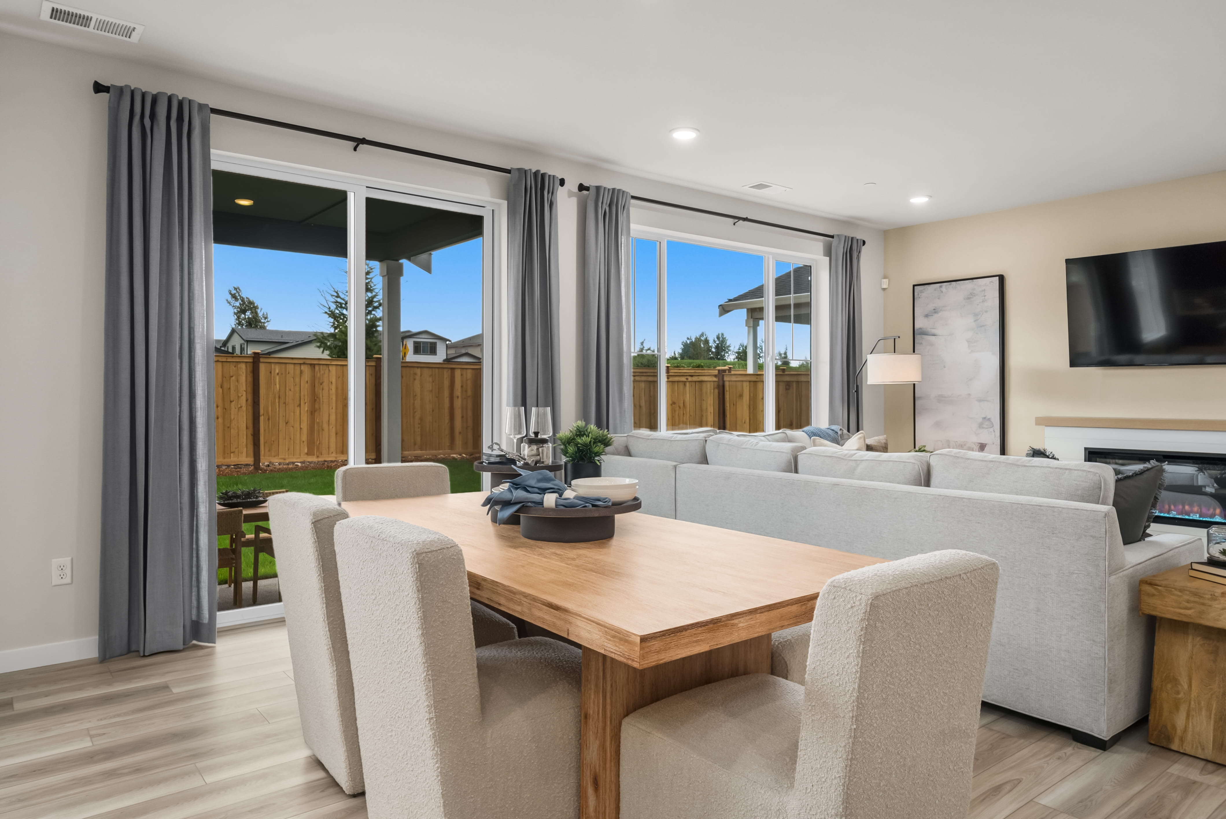 A living room with a large table and chairs.