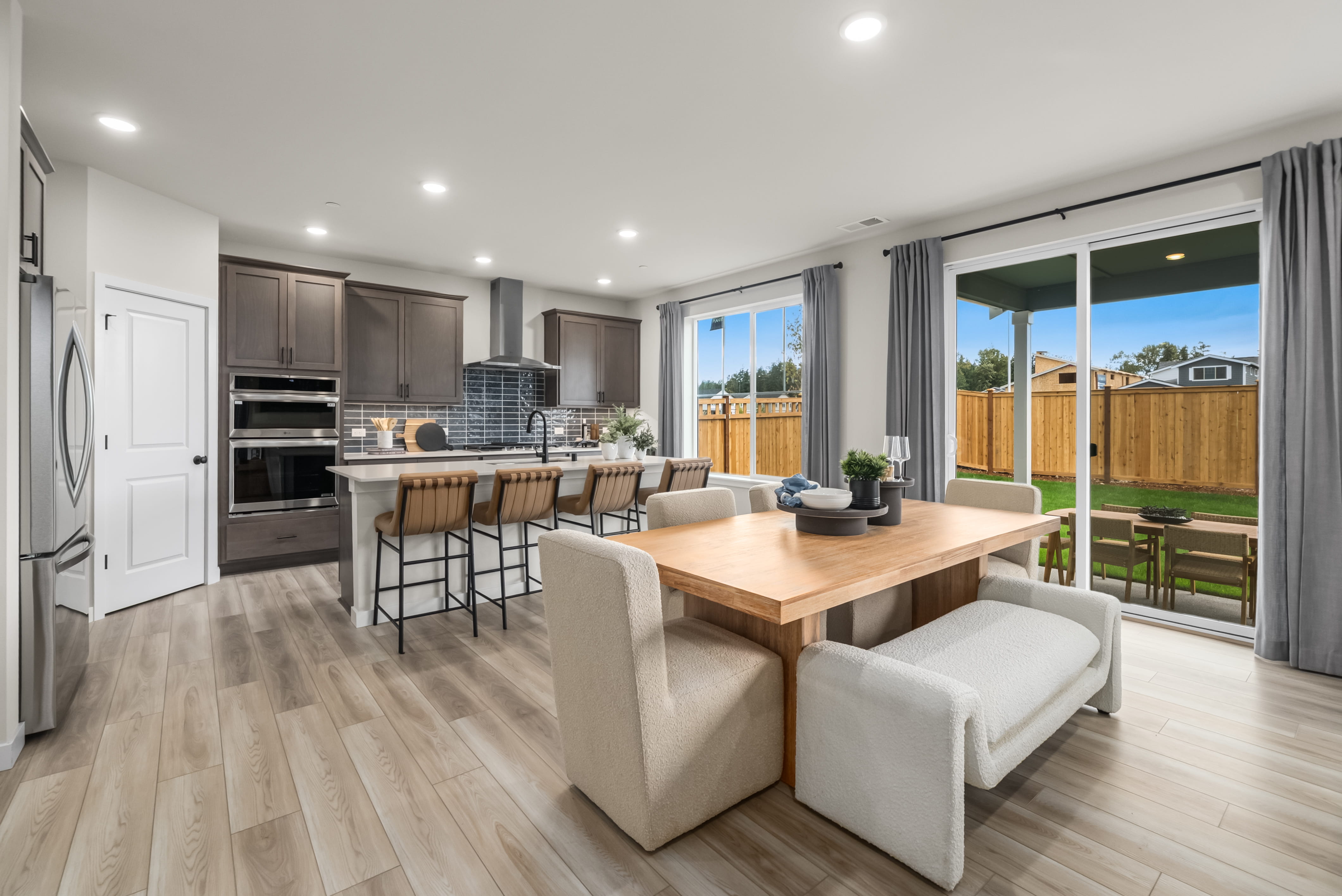 A large kitchen with a dining table and chairs.