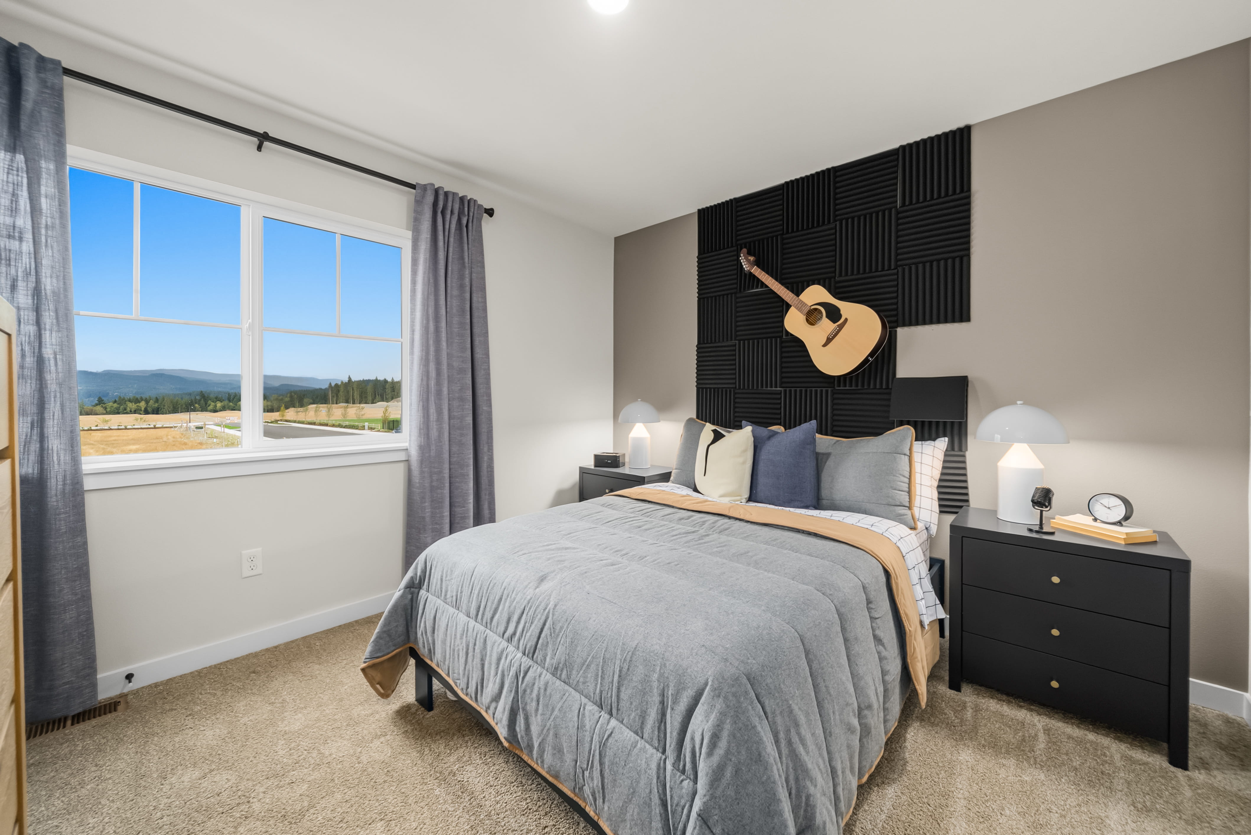 A bedroom with a large window.