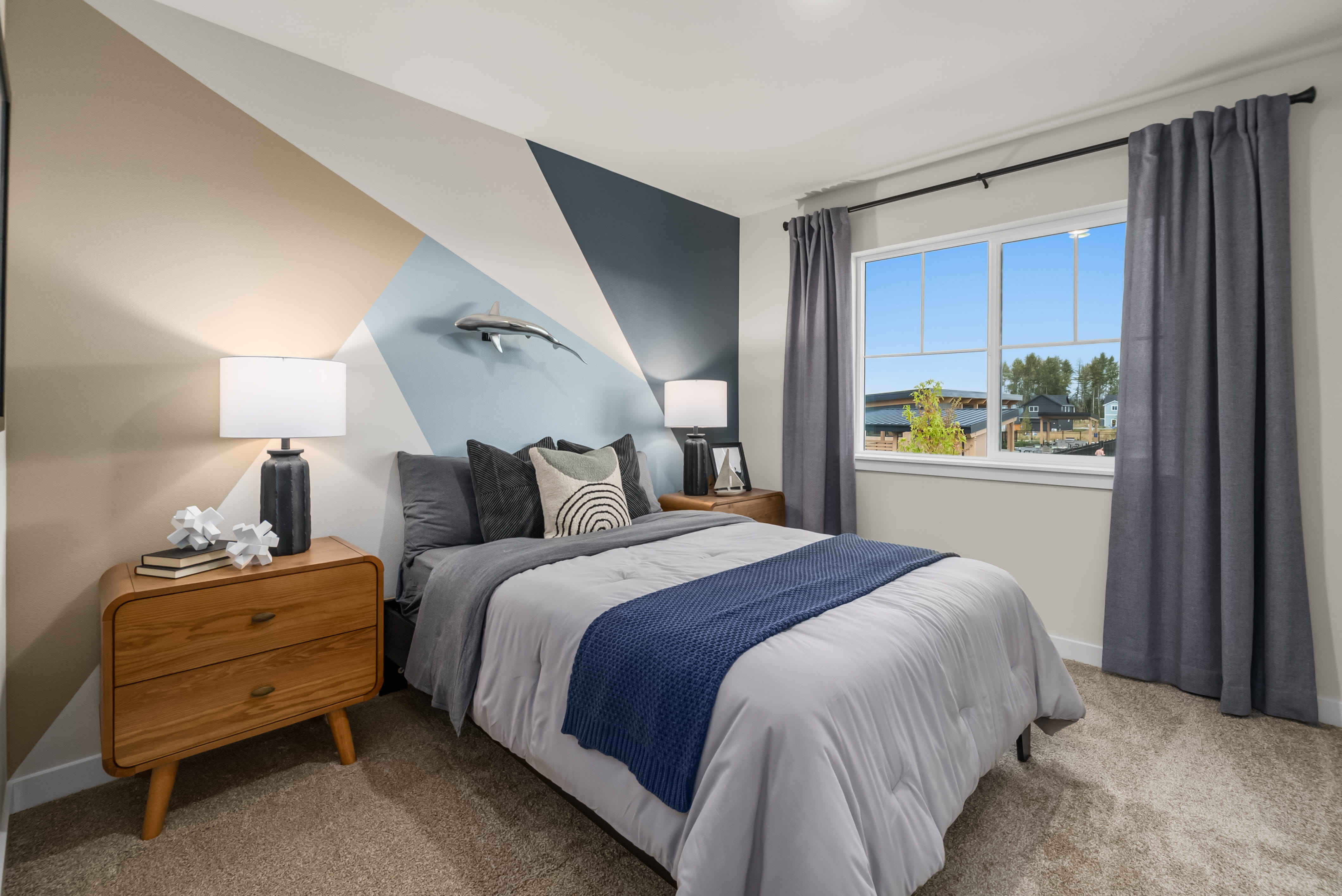 A bedroom with a bed and a window.