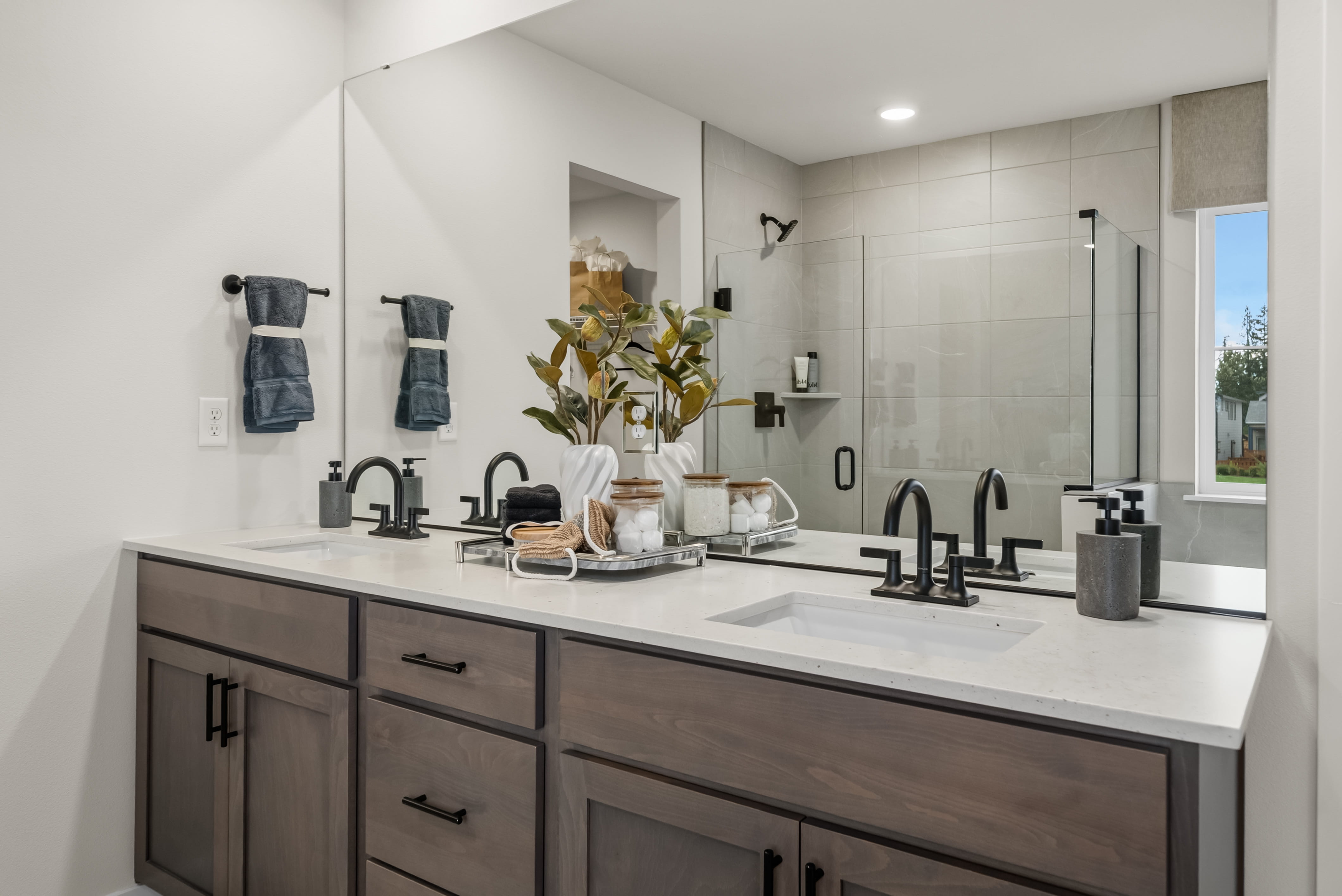 A bathroom with a large mirror.