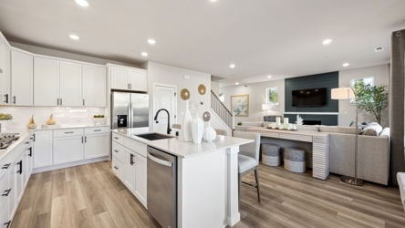 A kitchen with white cabinets.