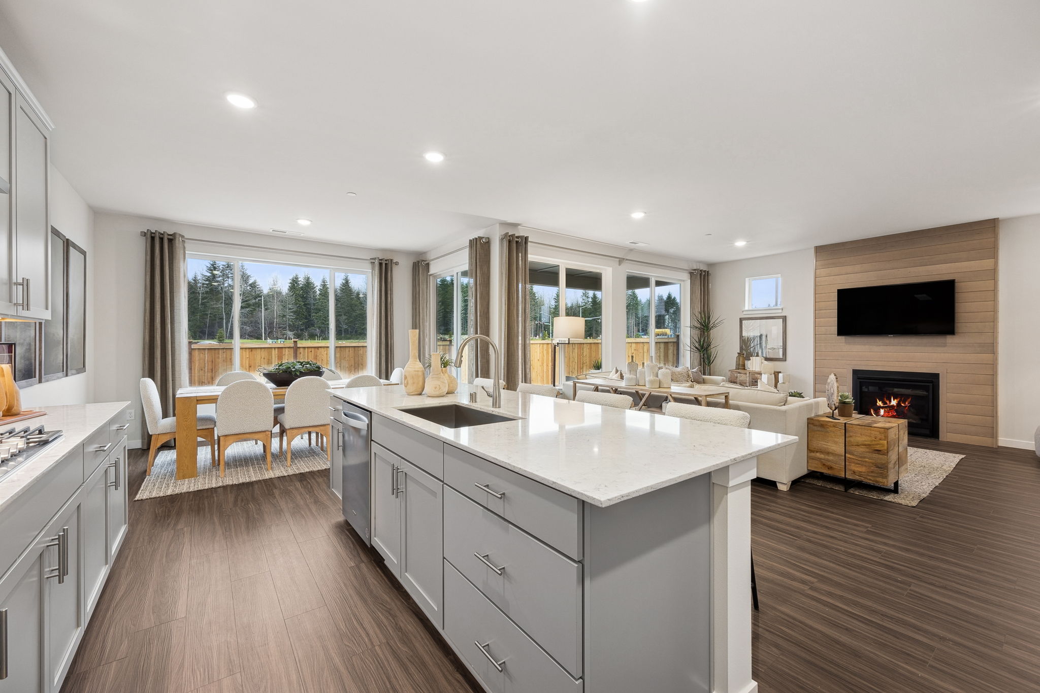 A kitchen with a fireplace and a large window.