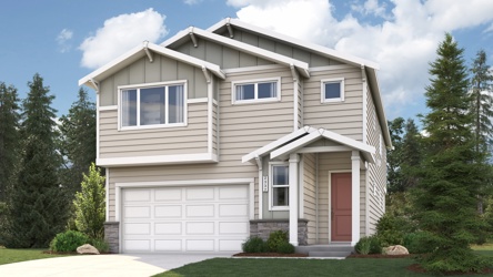 A house with a garage and trees.