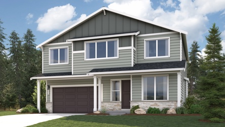 A house with a garage and trees.