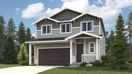 A house with a garage and trees around it.