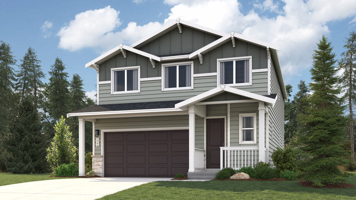 A house with a garage and trees around it.