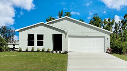 A white house with a garage.