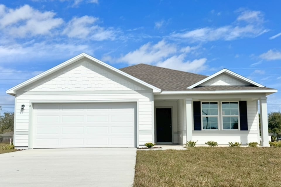 A white house with a garage.