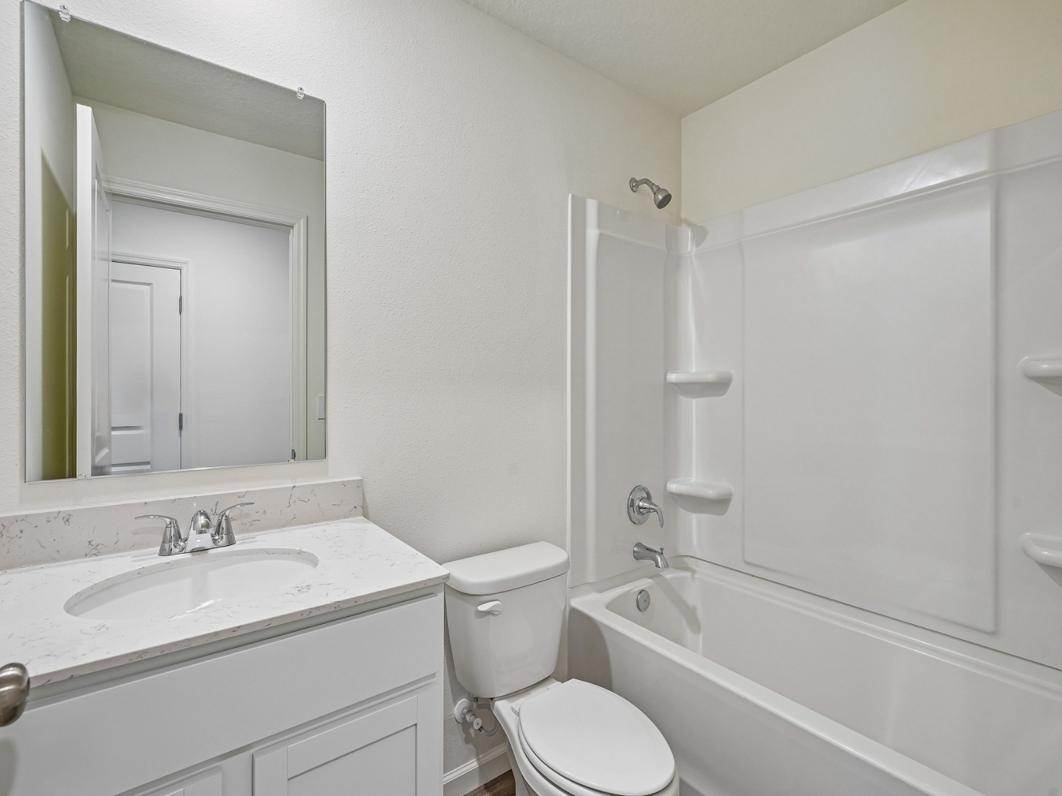 A bathroom with a tub sink and toilet.