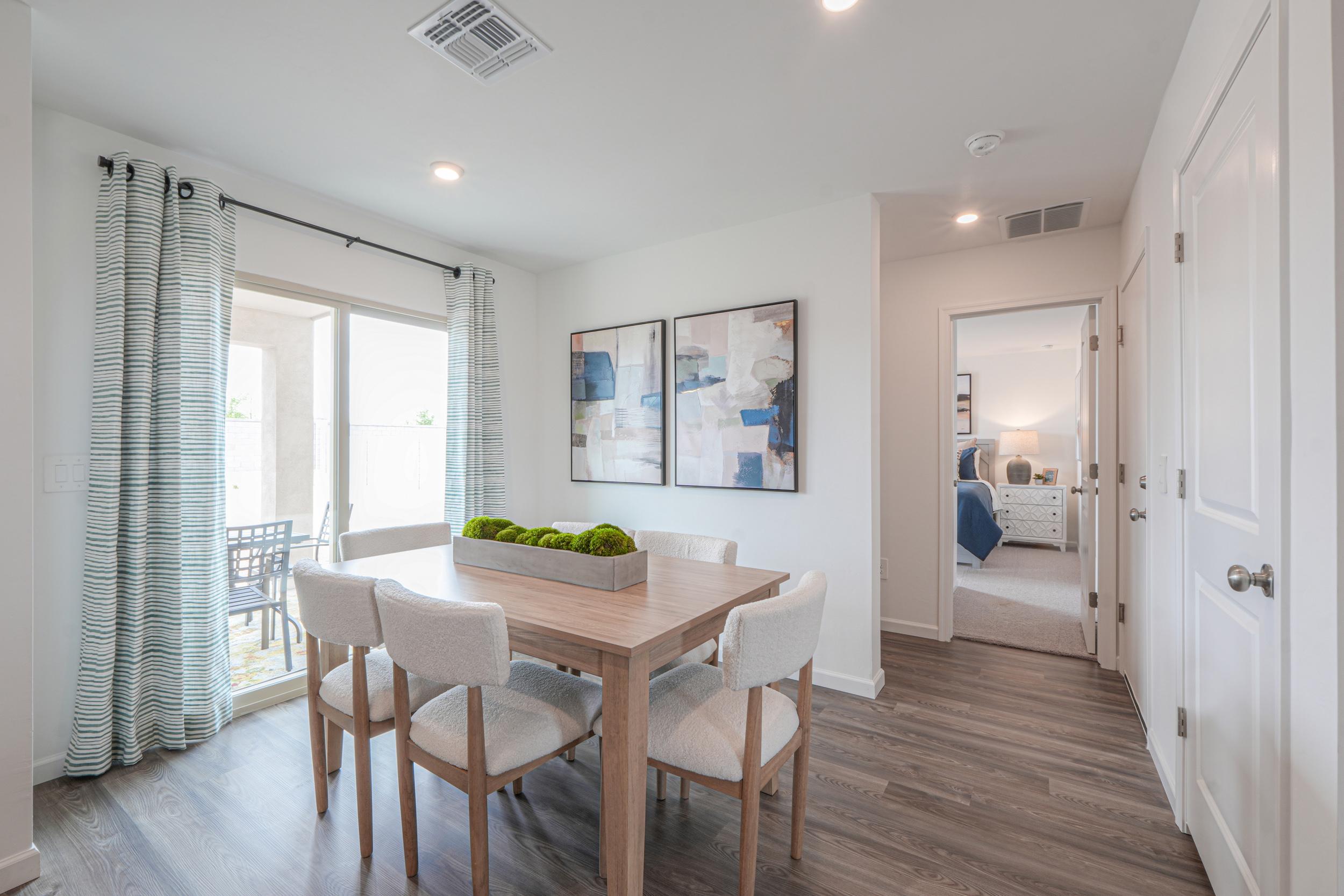 A dining room with a table and chairs.
