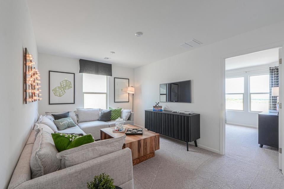 A living room with a tv and couches.
