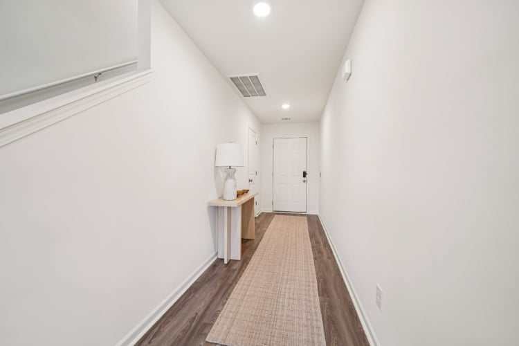 A hallway with white walls.